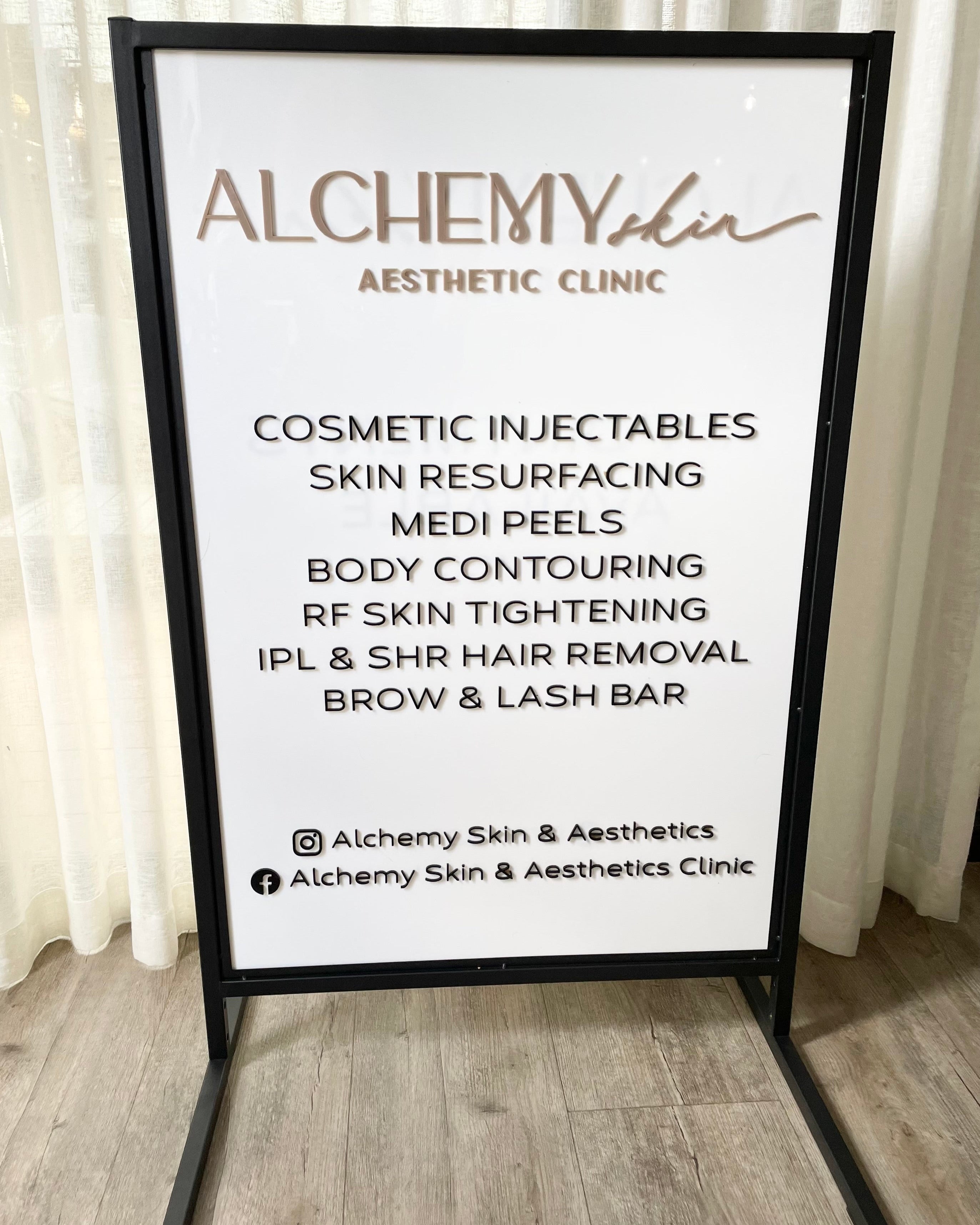 White T frame outdoor advertising sign with cosmetic clinic logo