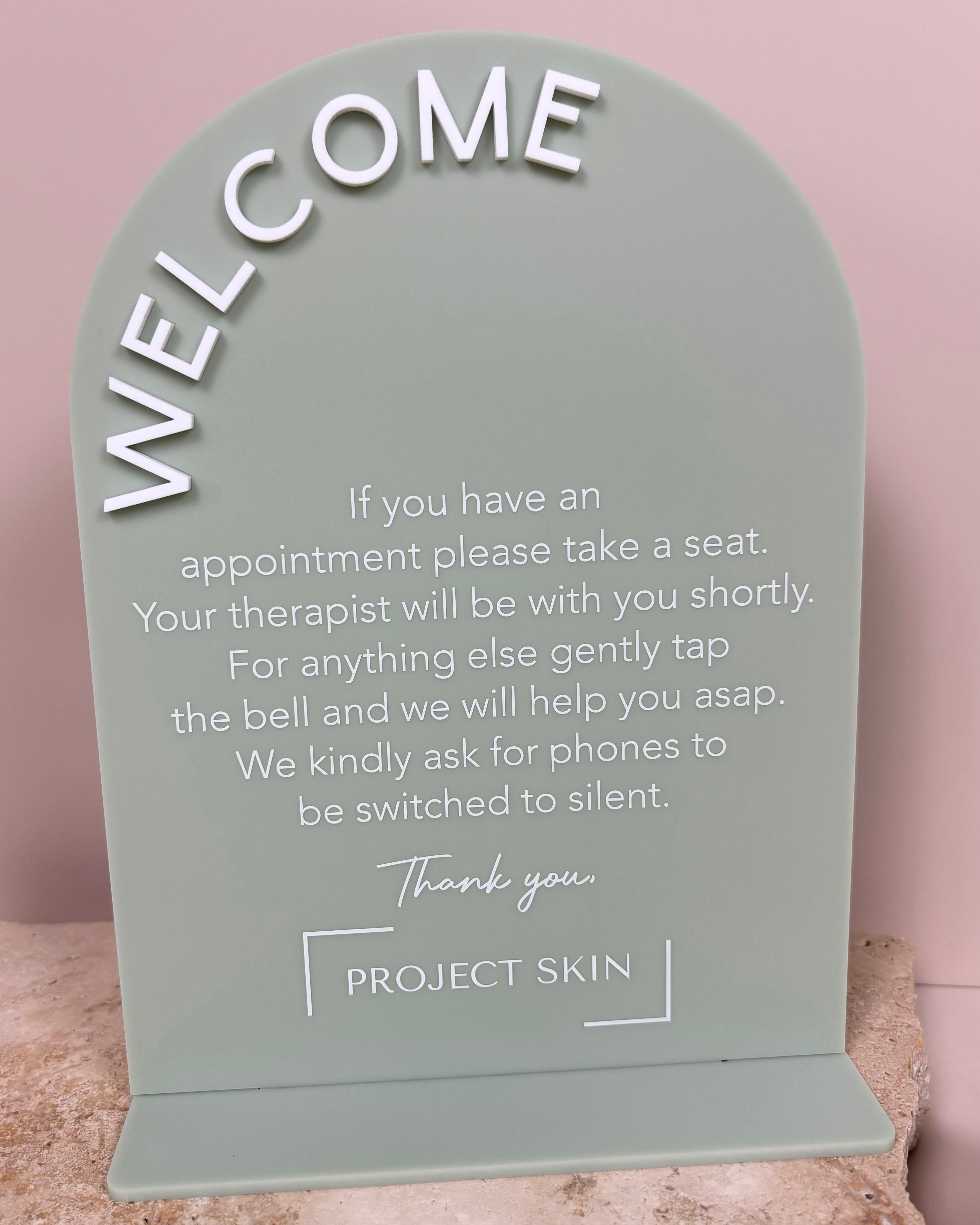 Green welcome stand with client information and logo