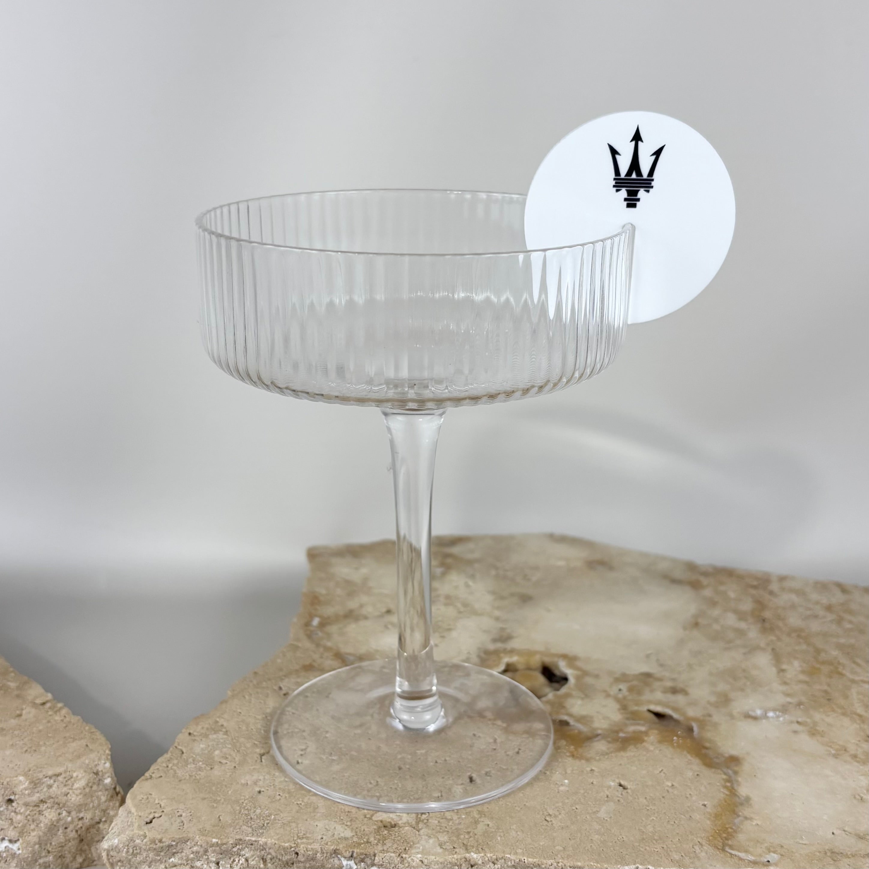 Custom acrylic logo drink tag attached to cocktail glass for weddings, events and branded celebrations