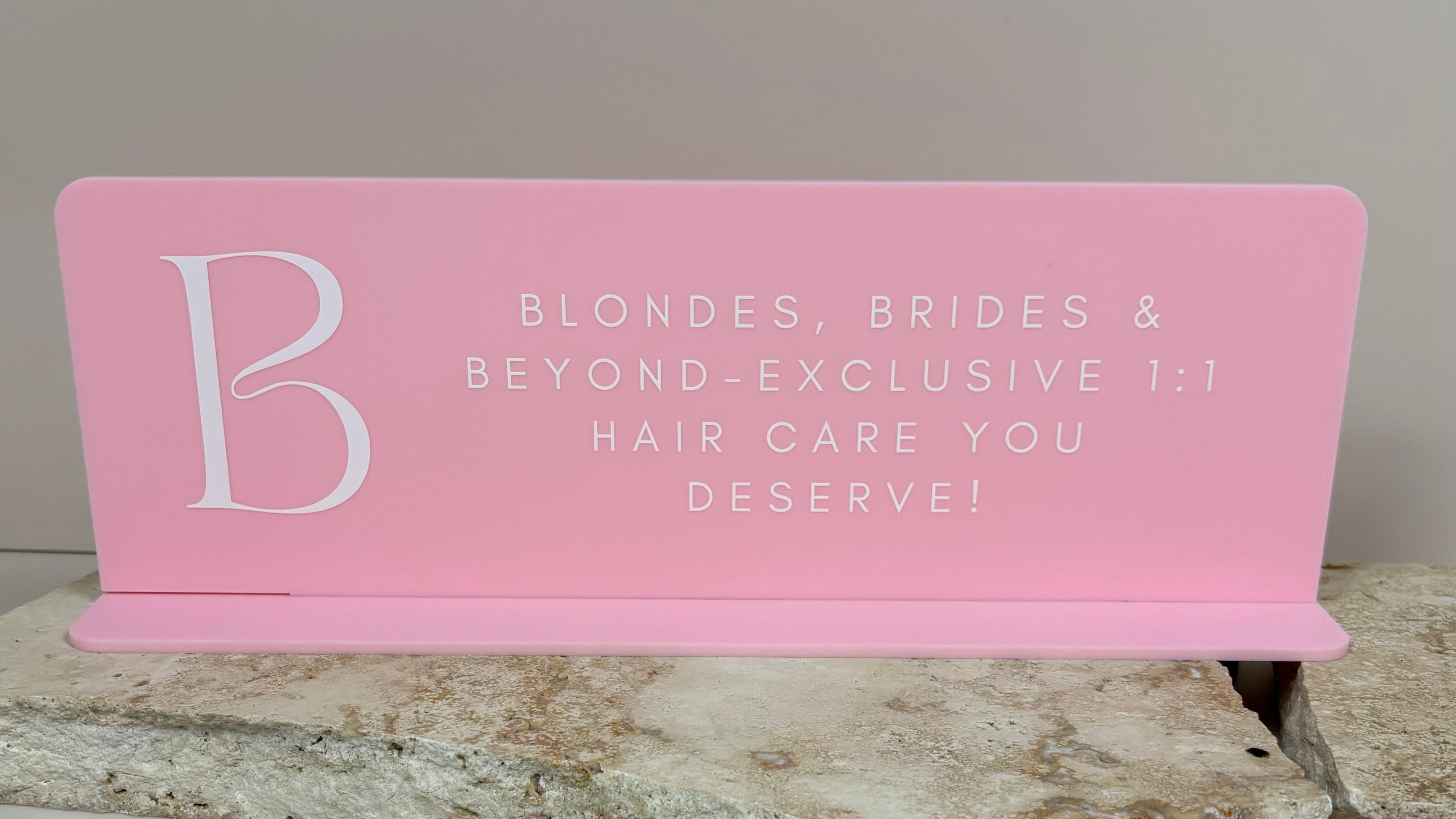 Branded pink acrylic salon sign for hair care and bridal services