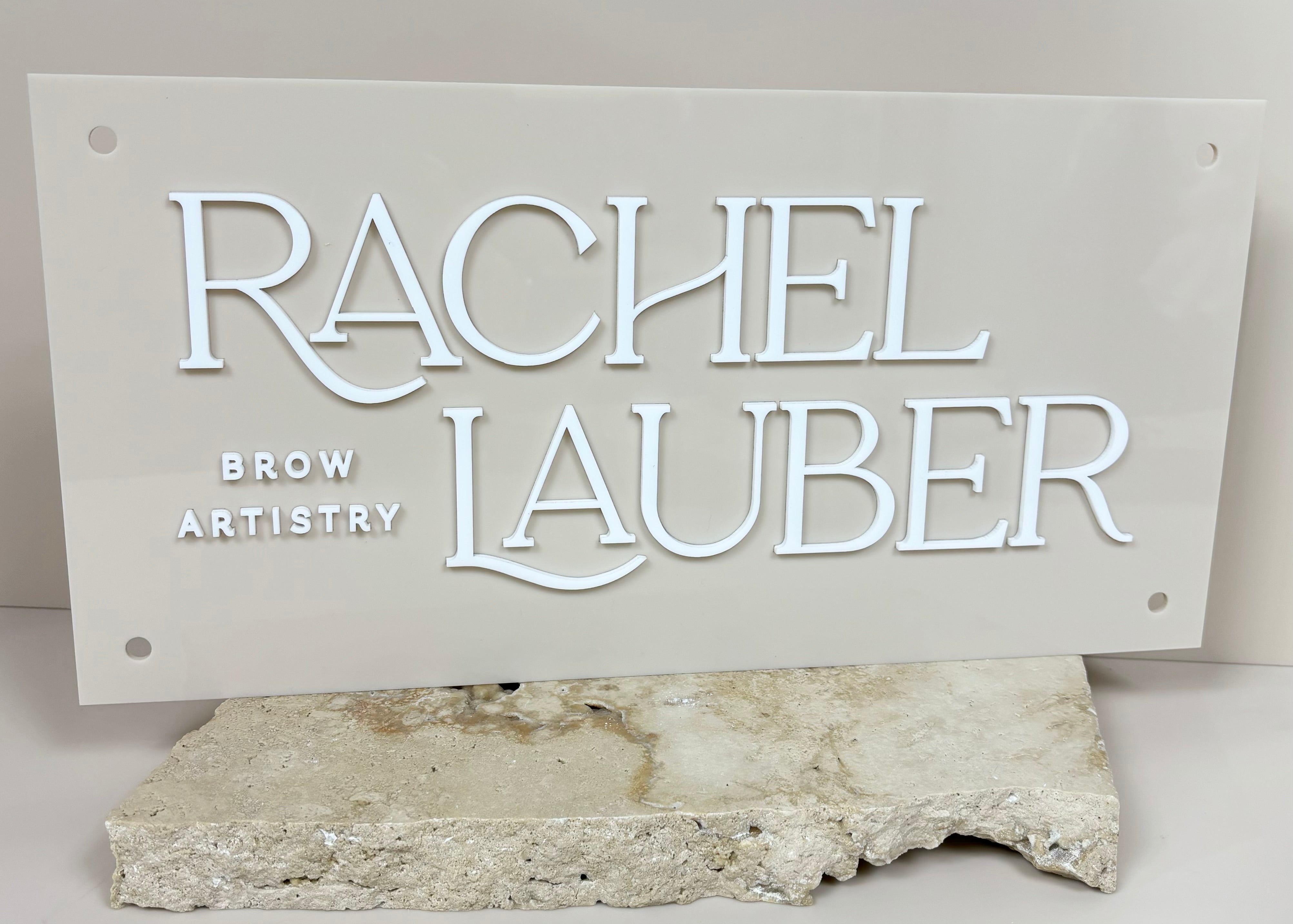 White 3D lettering on neutral rectangle acrylic sign for Rachel Lauber