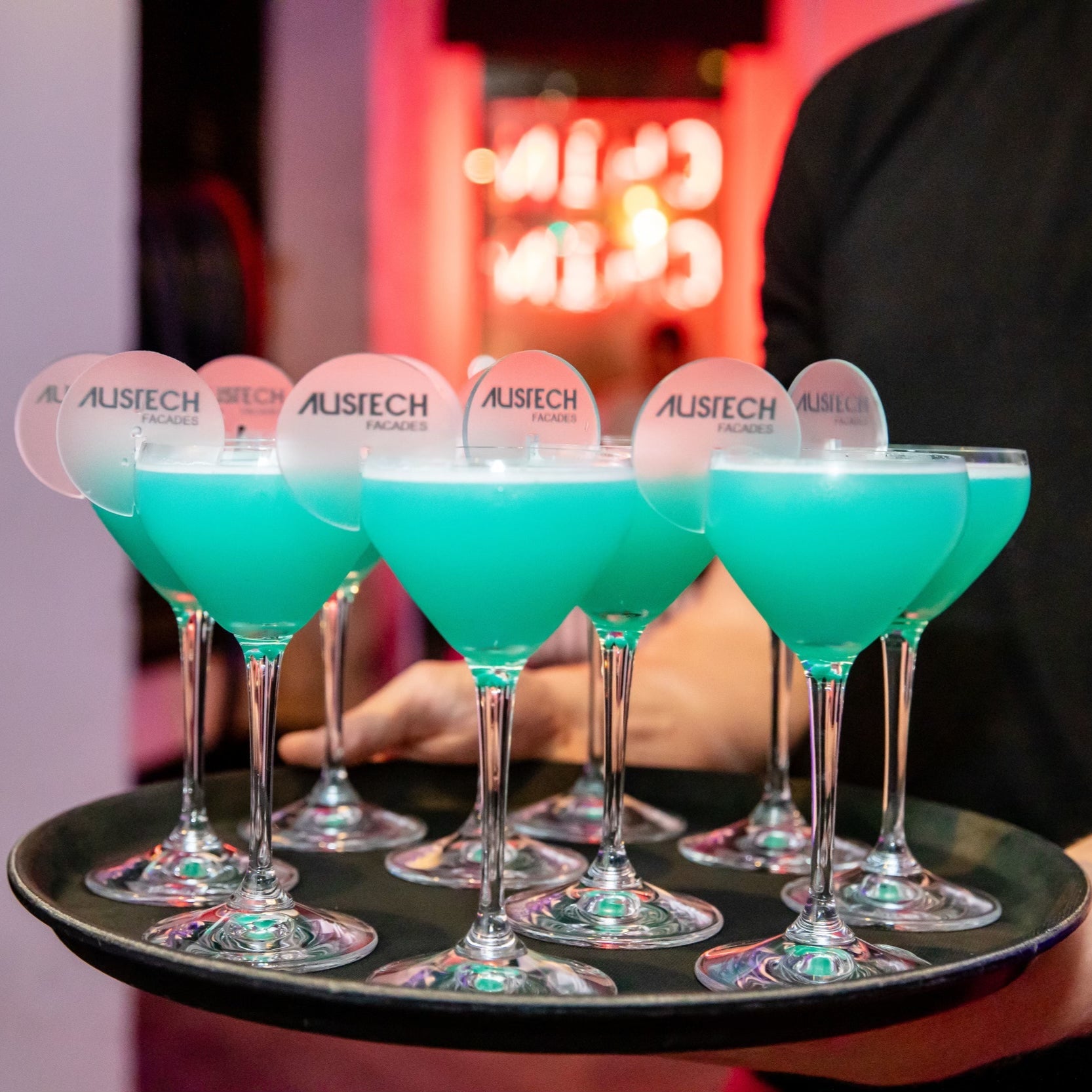 Blue cocktails on a tray with personalised branded drink tags