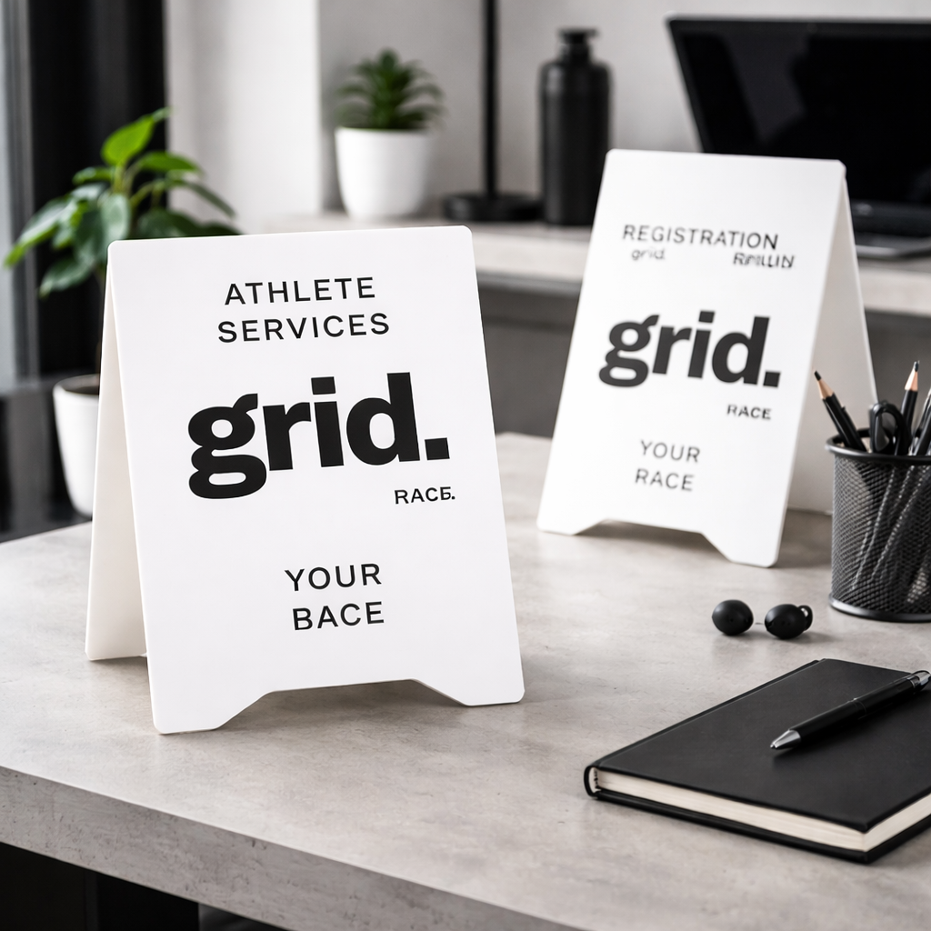 Custom acrylic A-frame sign on modern desk, premium business signage for event registration, reception displays and fitness brand setups Australia