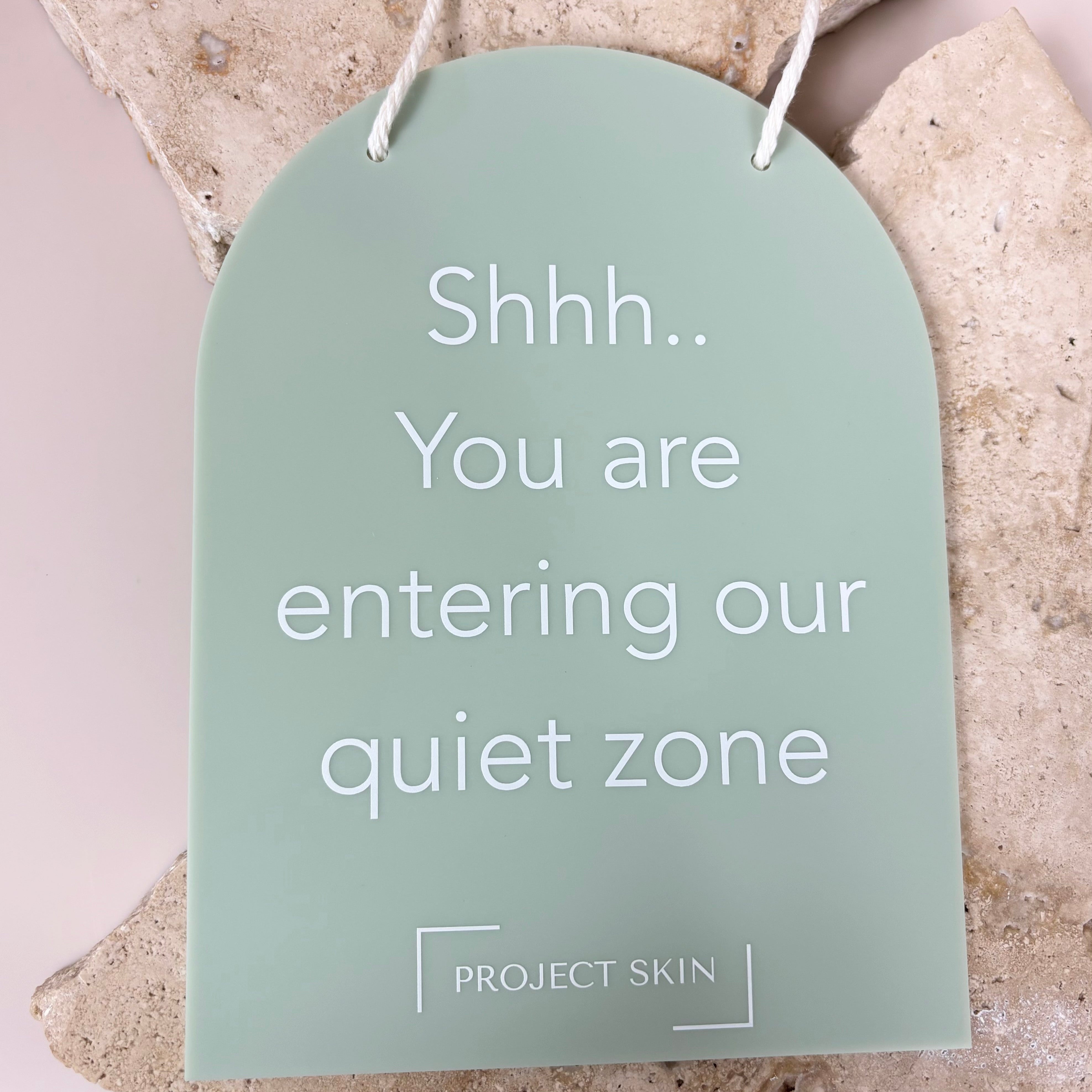 Green mini arched info sign with engraved message “Shhh… You are entering our quiet zone” styled on soft fabric