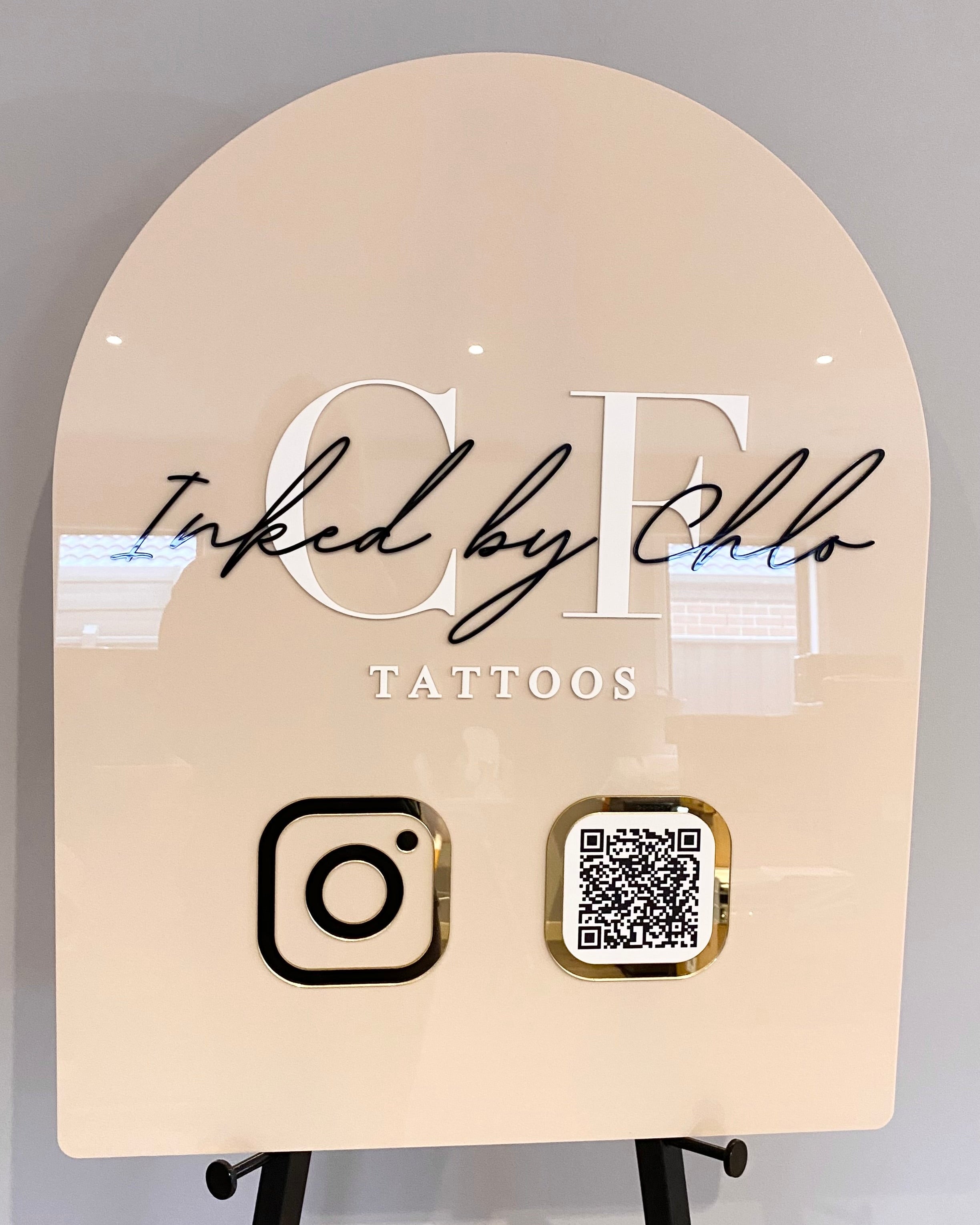 Peach arch sign with business name and QR code