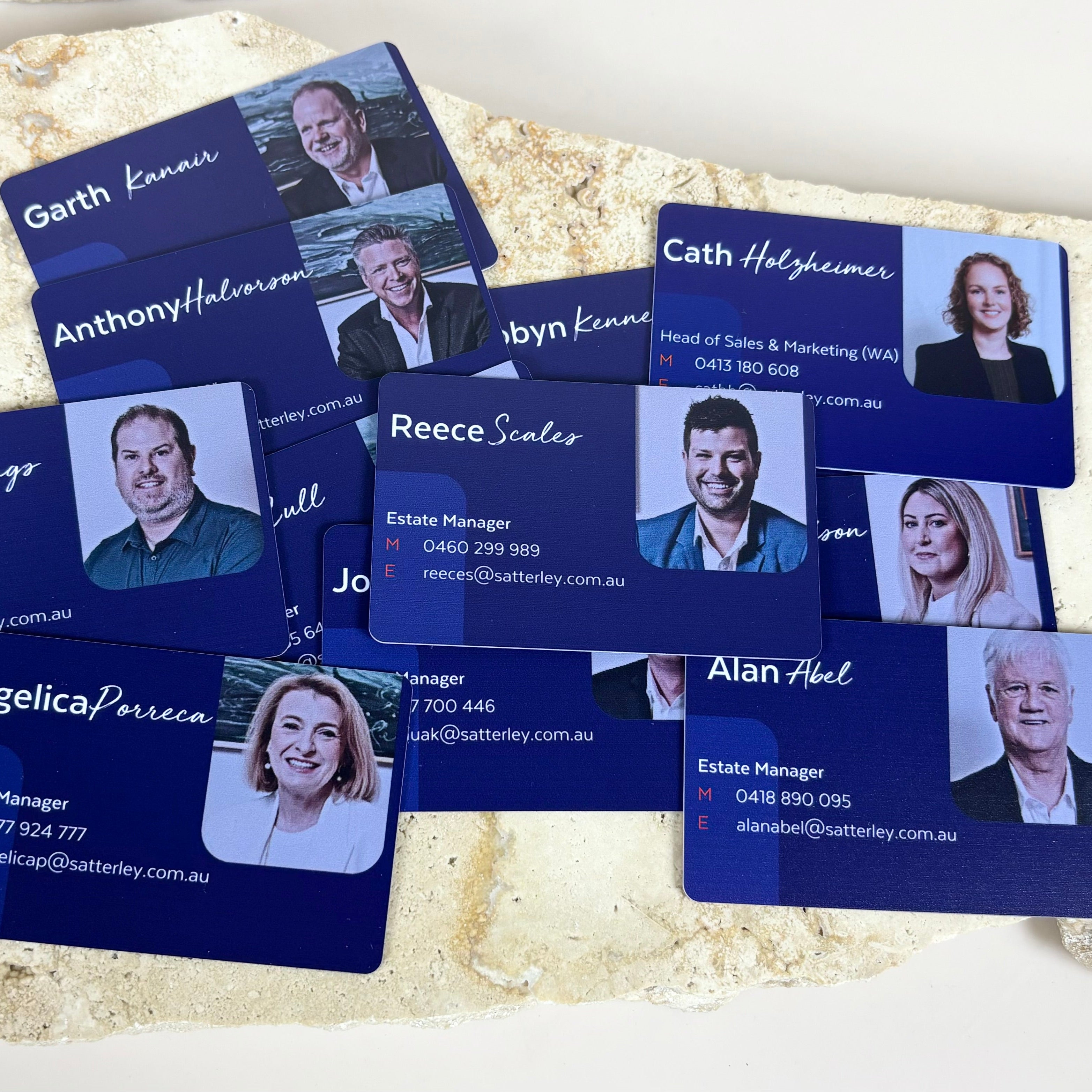 Printed staff NFC cards with headshots and LinkedIn-style business layout