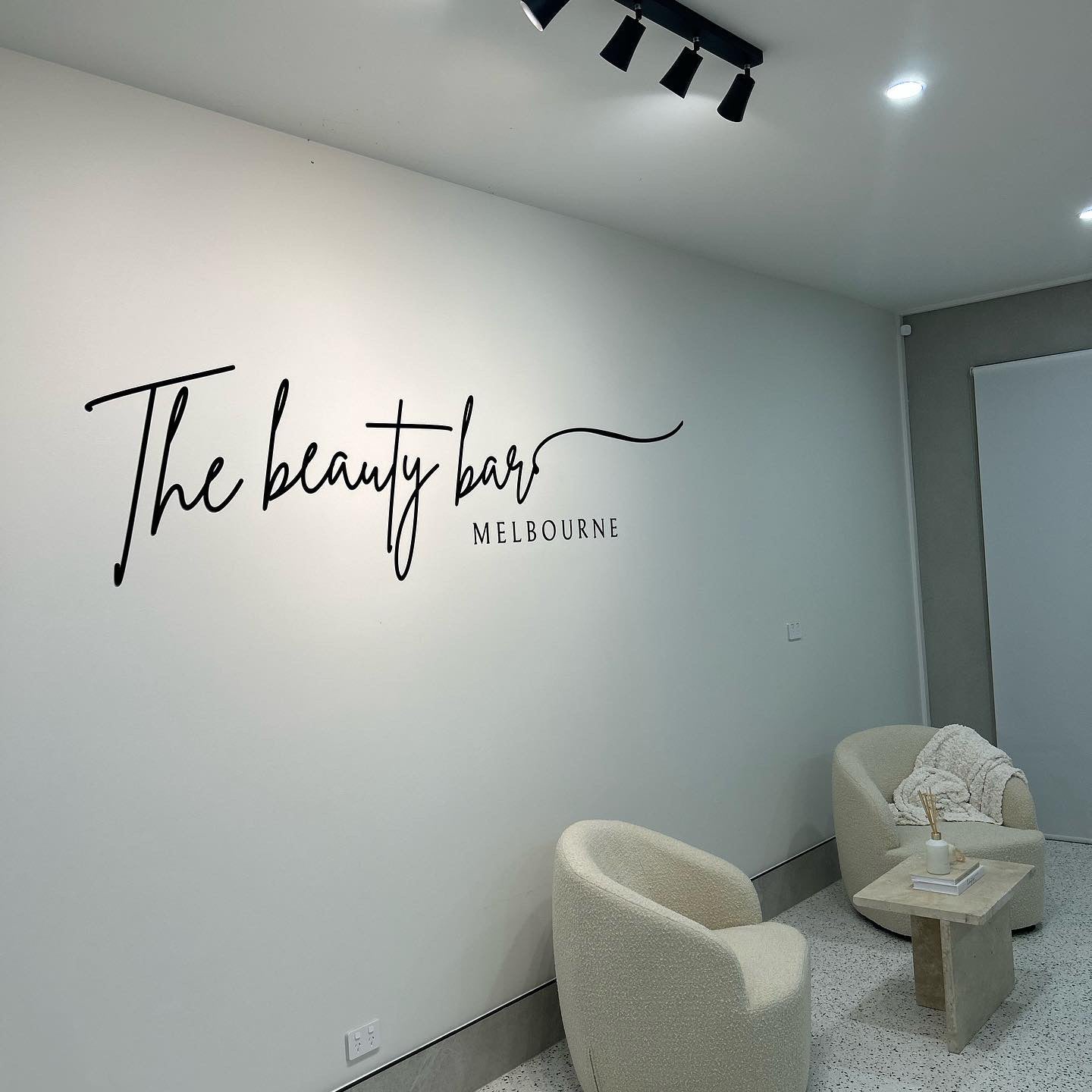 gloss black acrylic lettering signage for salon space