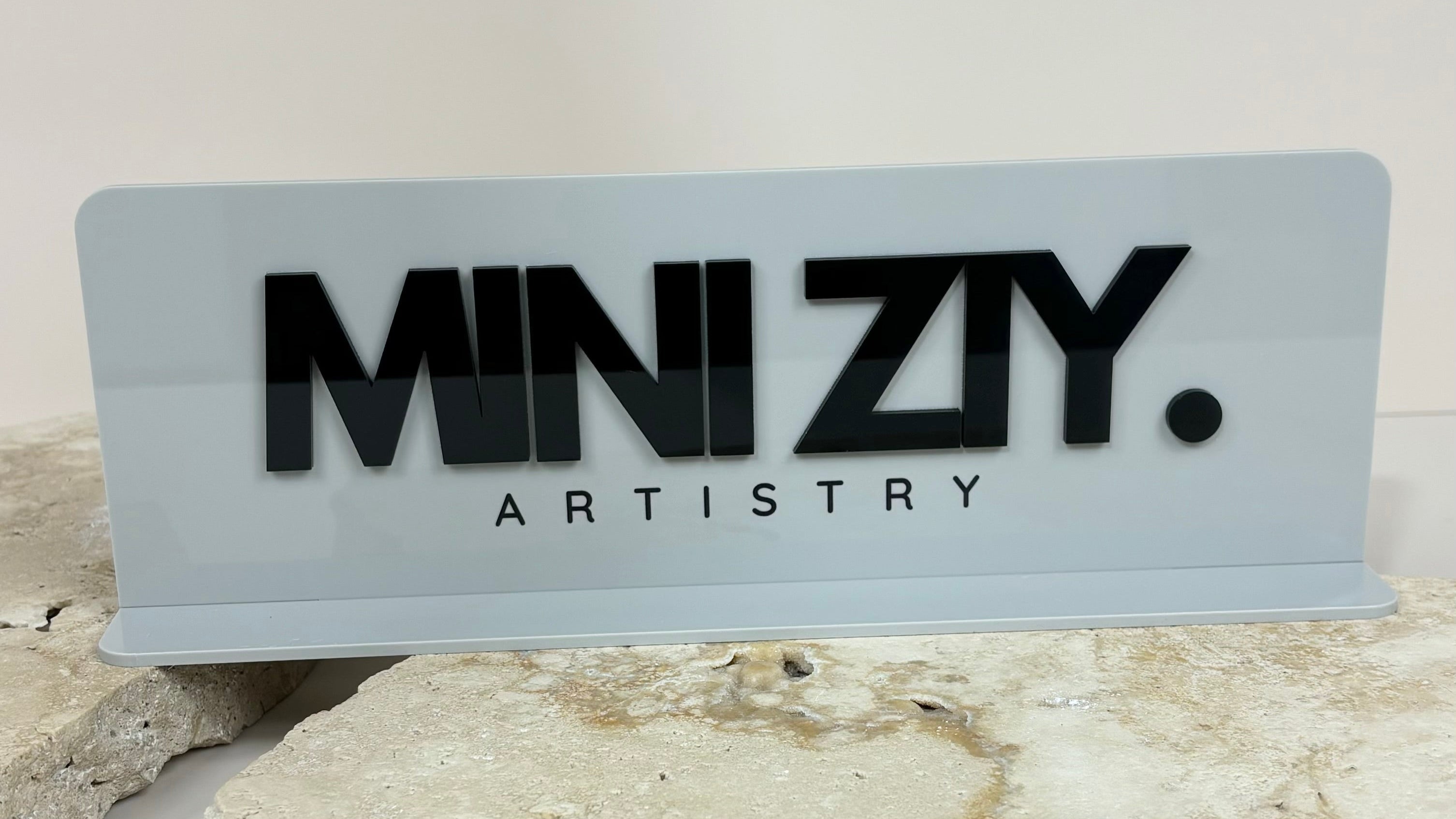 White acrylic slim counter stand with bold business logo for beauty branding