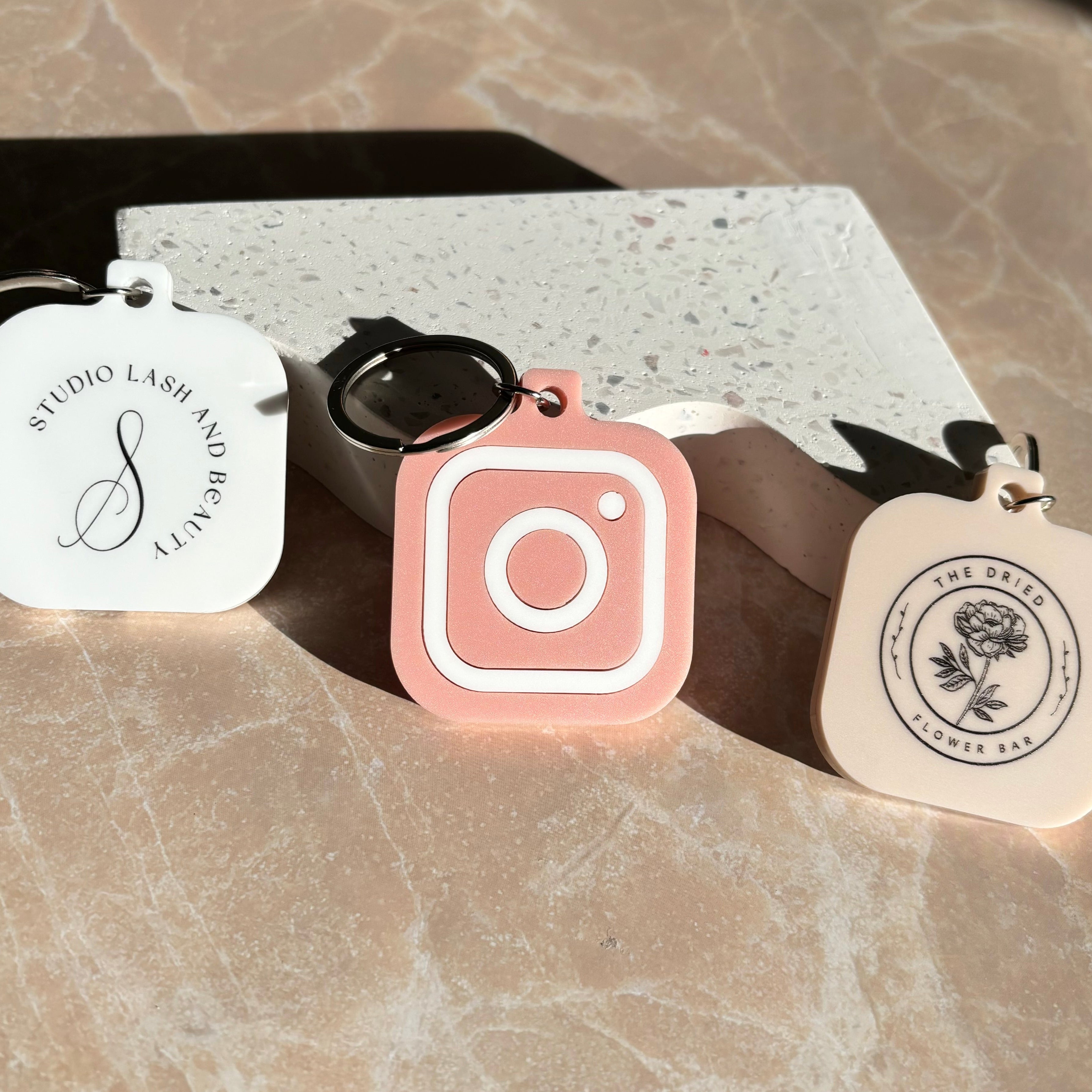 Custom business NFC keychain tags with social icons and printed monograms