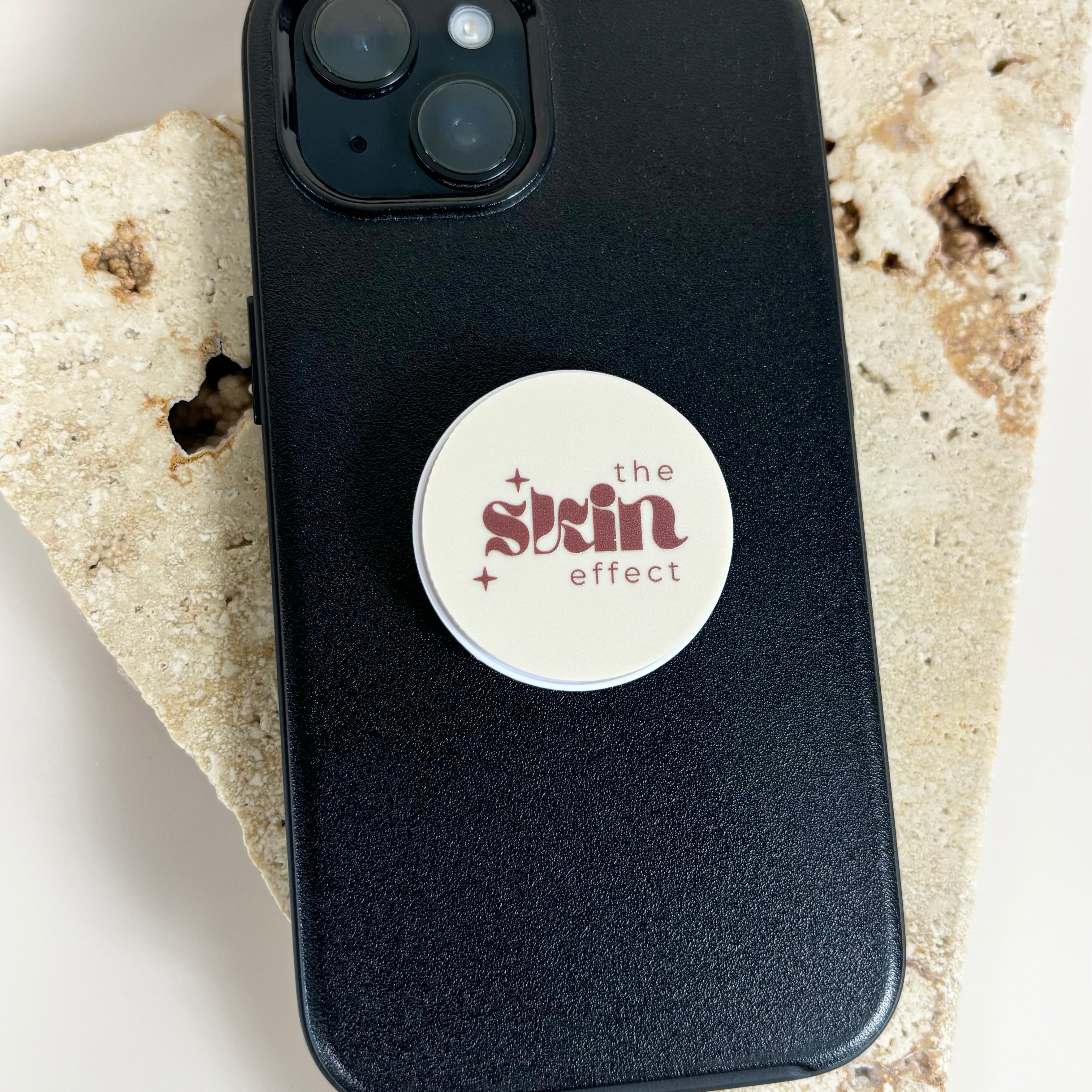 Custom printed phone grip showing business logo on smartphone