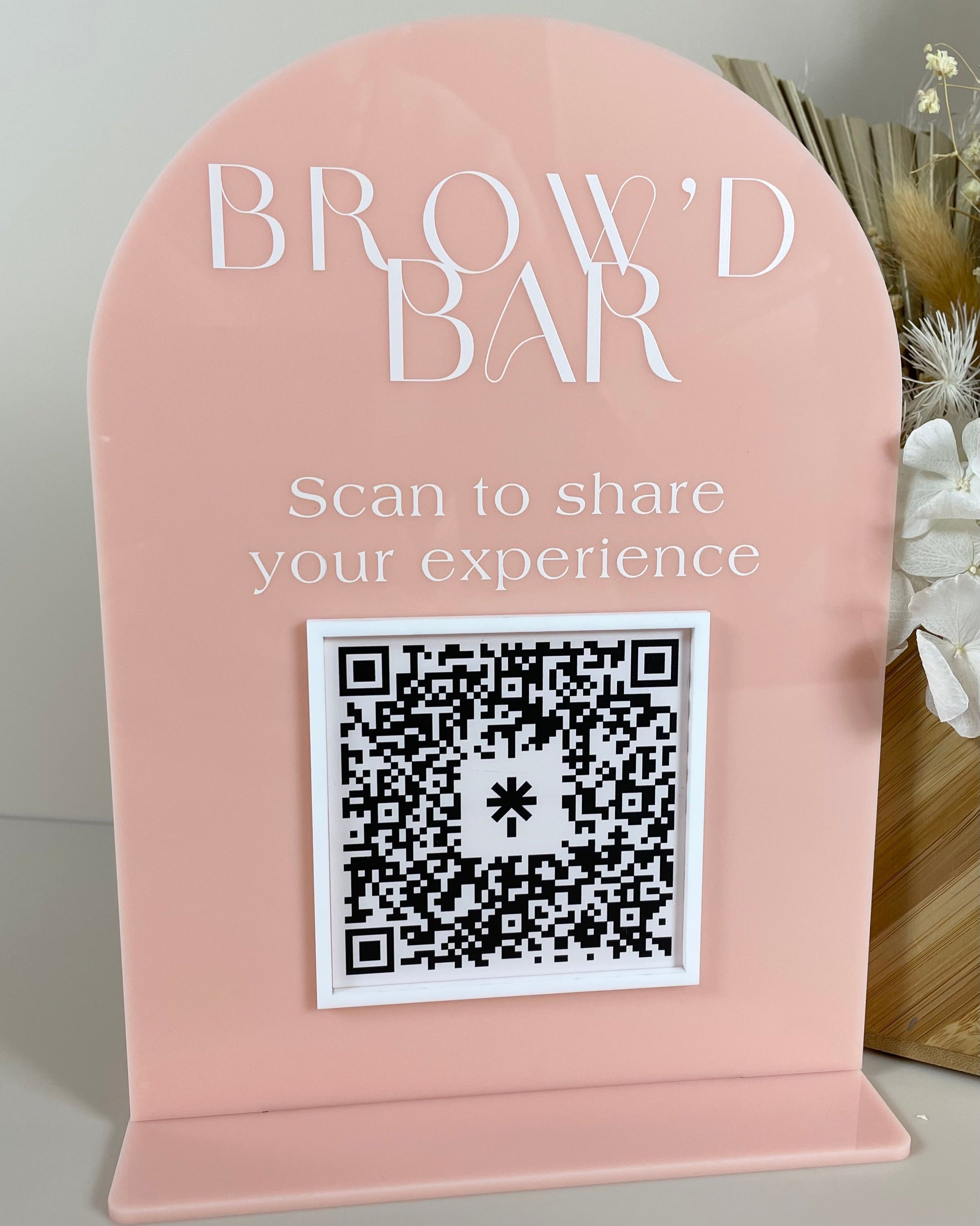 Pink business sign with QR code for customer feedback and reviews