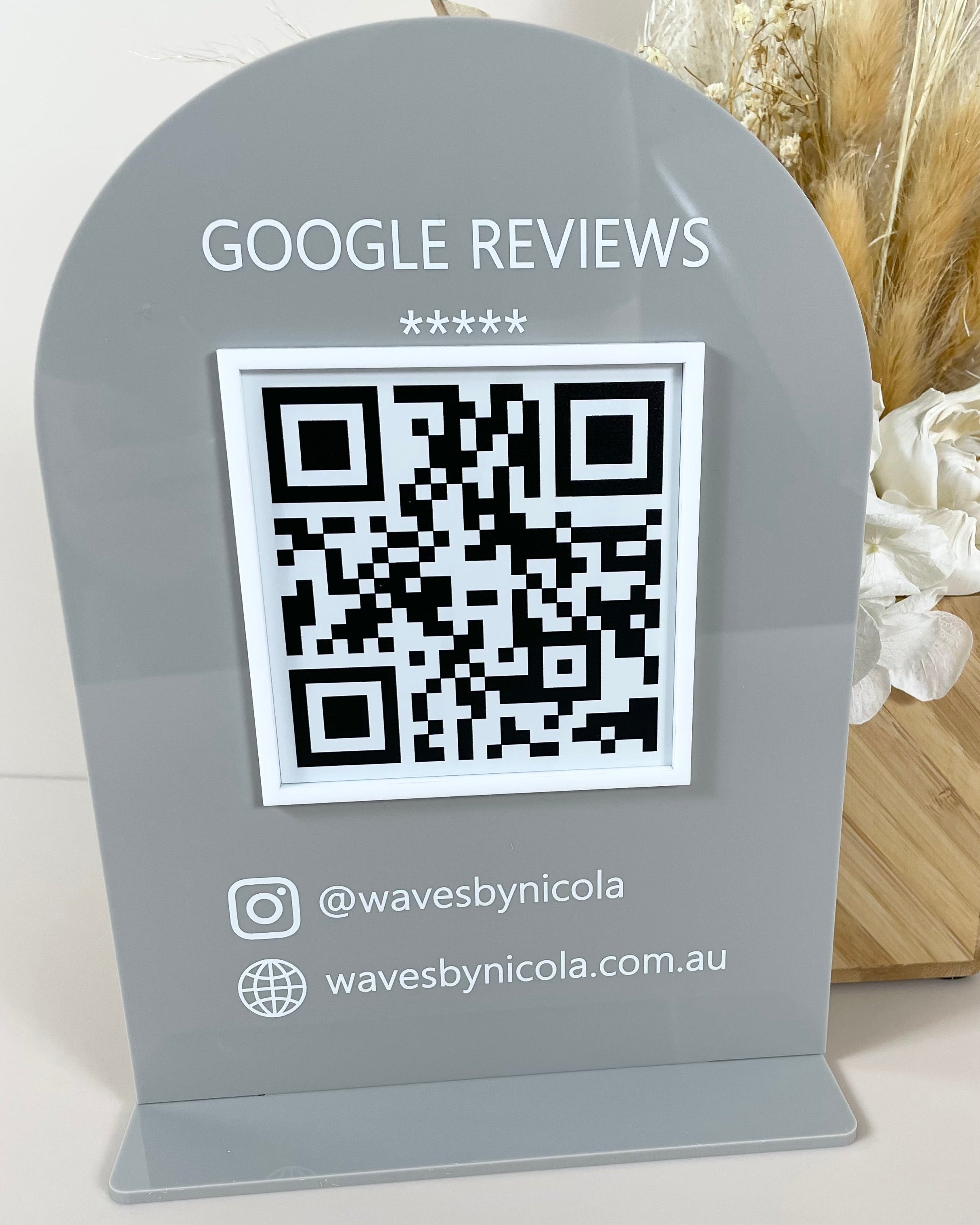 Dark grey acrylic review sign with QR code and website link