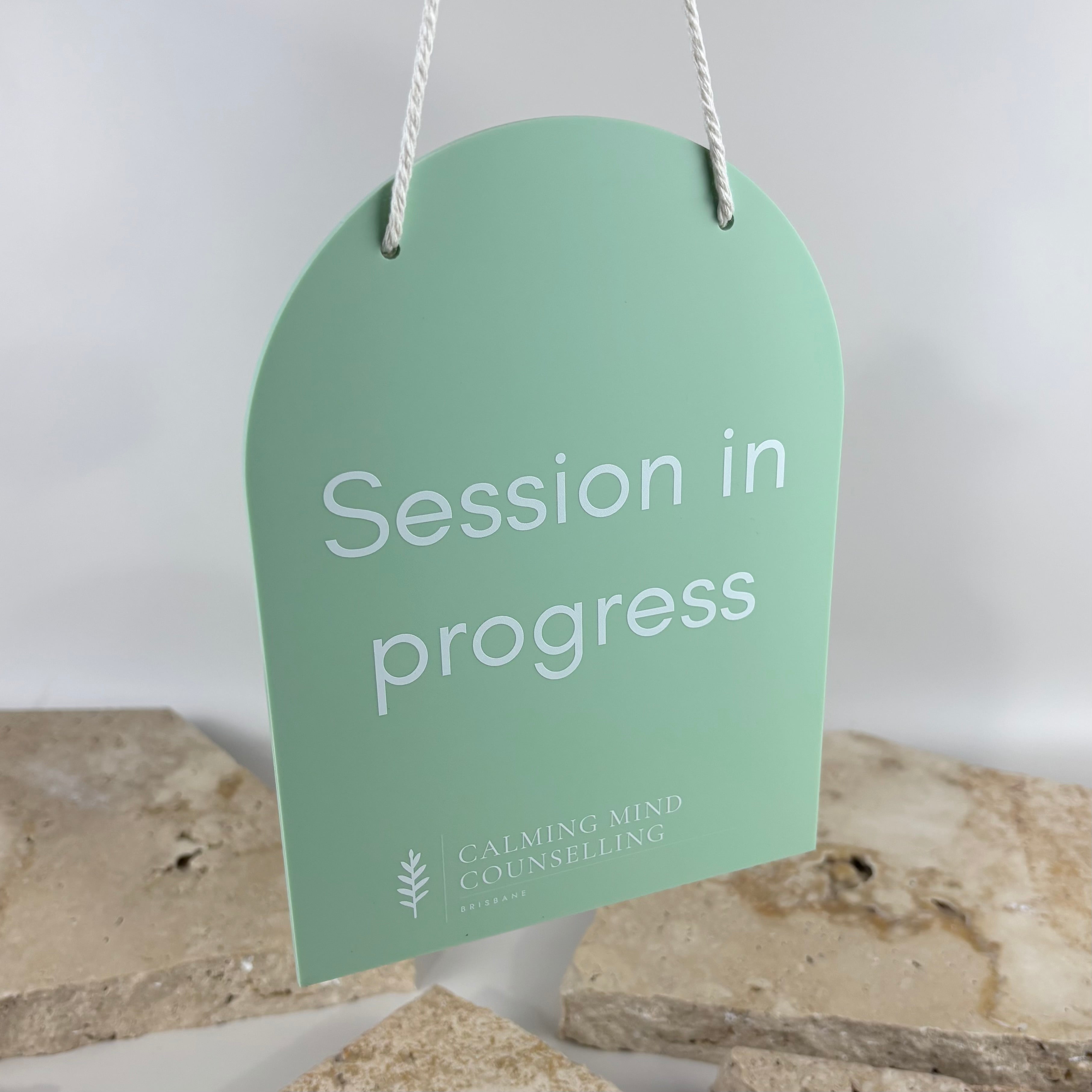 Custom Session in Progress Sign for Counselling Clinics – Sage green acrylic hanging door sign with UV printed text and white rope hanger. Professional privacy sign for counsellors, psychologists, therapists, wellness clinics and consulting rooms, helping minimise interruptions during client sessions.