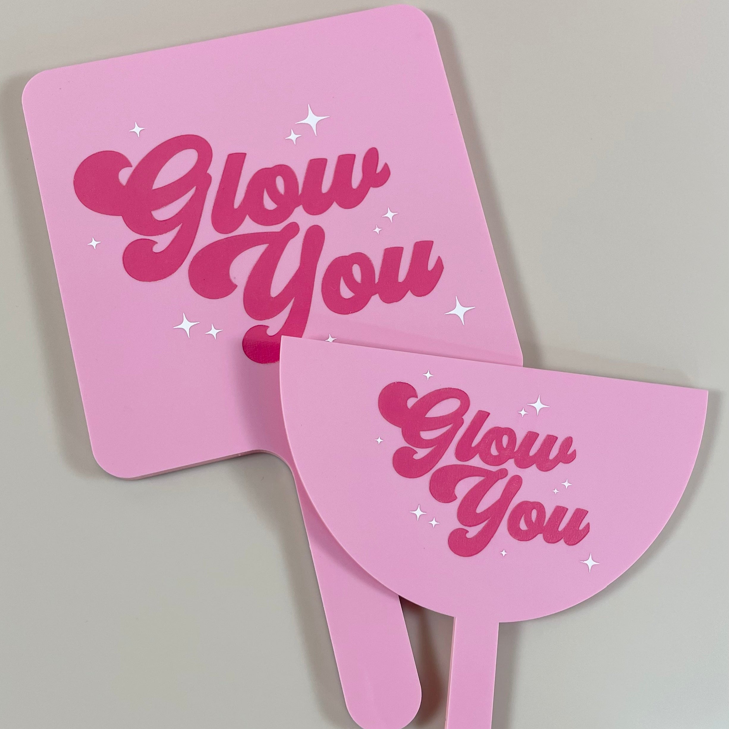 Hot pink acrylic salon mirror and face shield featuring Glow You salon branding