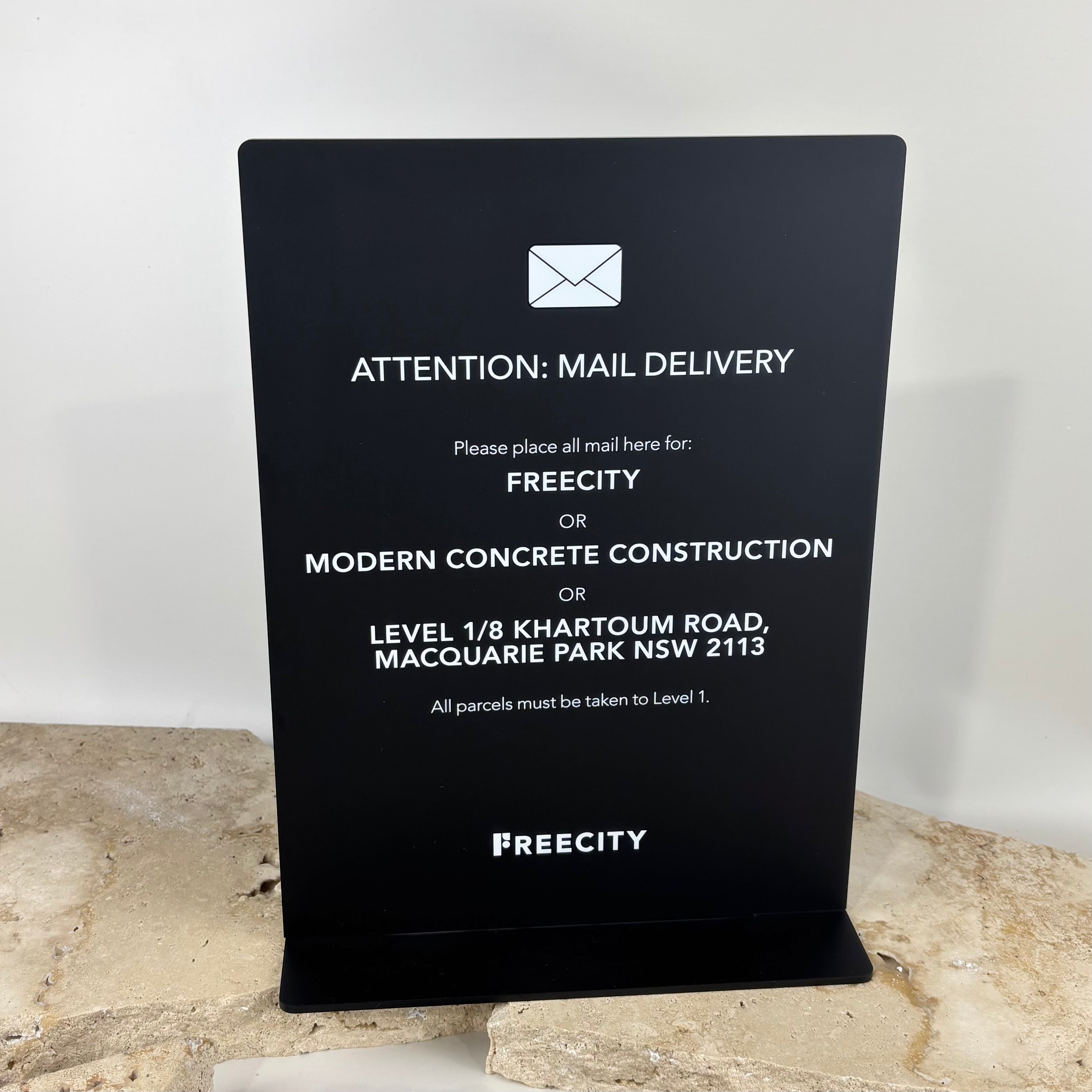 Black acrylic mail delivery sign with white UV printed text, freestanding base, custom business signage for office reception, parcel drop instructions sign Australia, modern corporate entry signage, personalised acrylic sign for mail and courier deliveries, Macquarie Park NSW office sign, sleek minimal business display sign