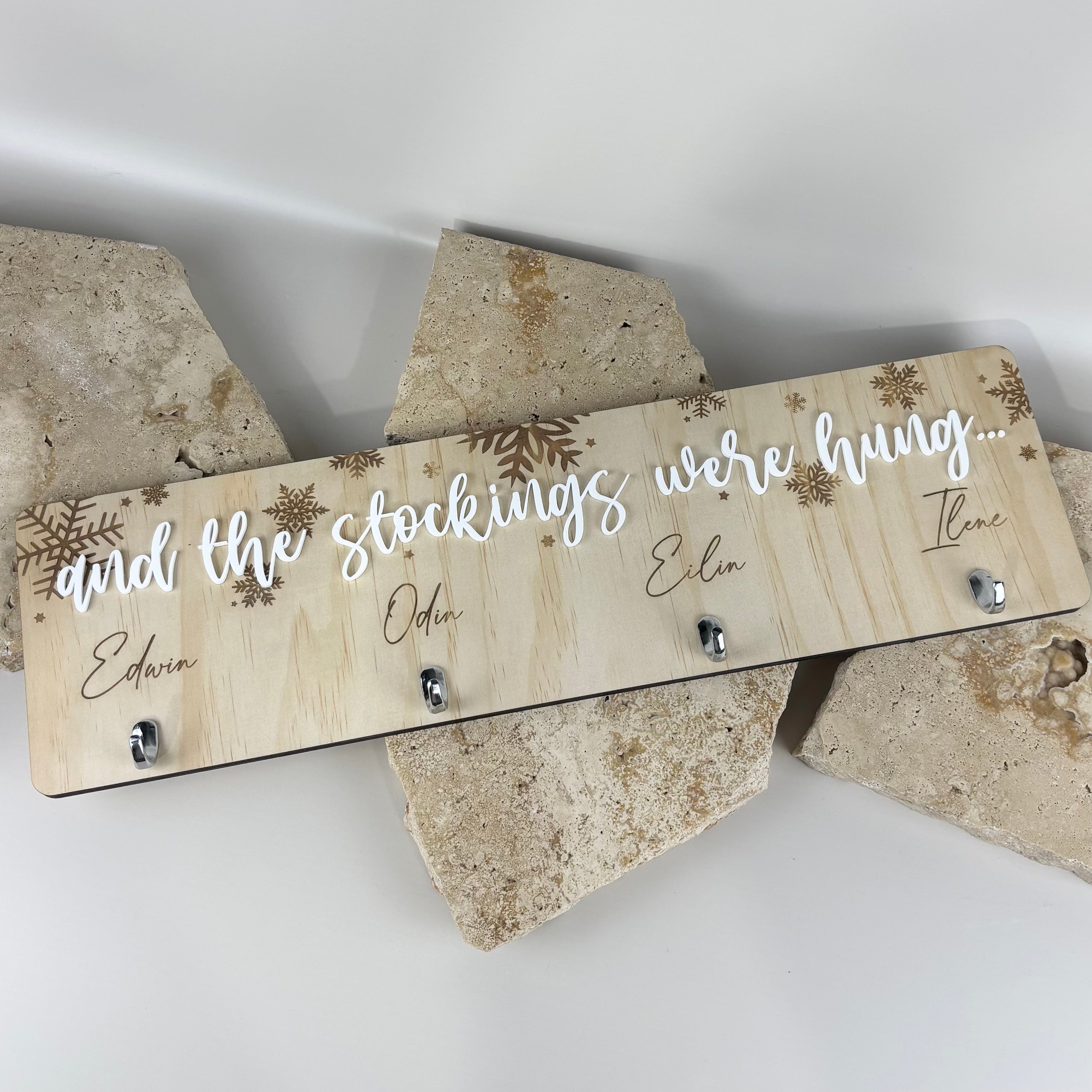 Personalised stocking hanger display with engraved names and hooks for hanging family stockings