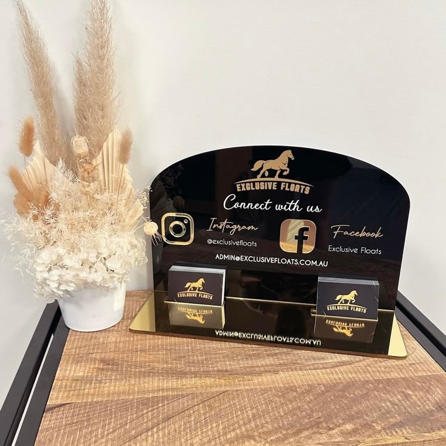 Custom black acrylic business display stand with gold mirror base featuring social media icons, Instagram and Facebook details, email contact and dual business card holders, ideal for reception desks, salons and small business branding in Australia.