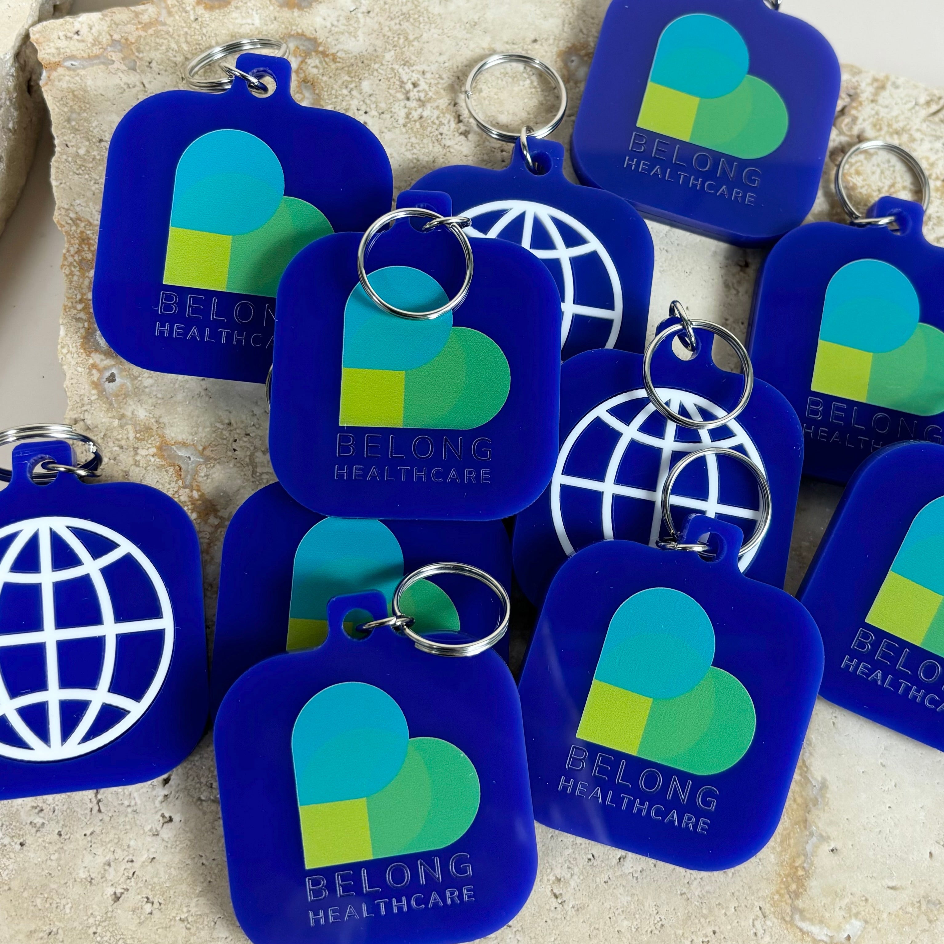 Bulk blue and green NFC tag keychains with global design for corporate branding