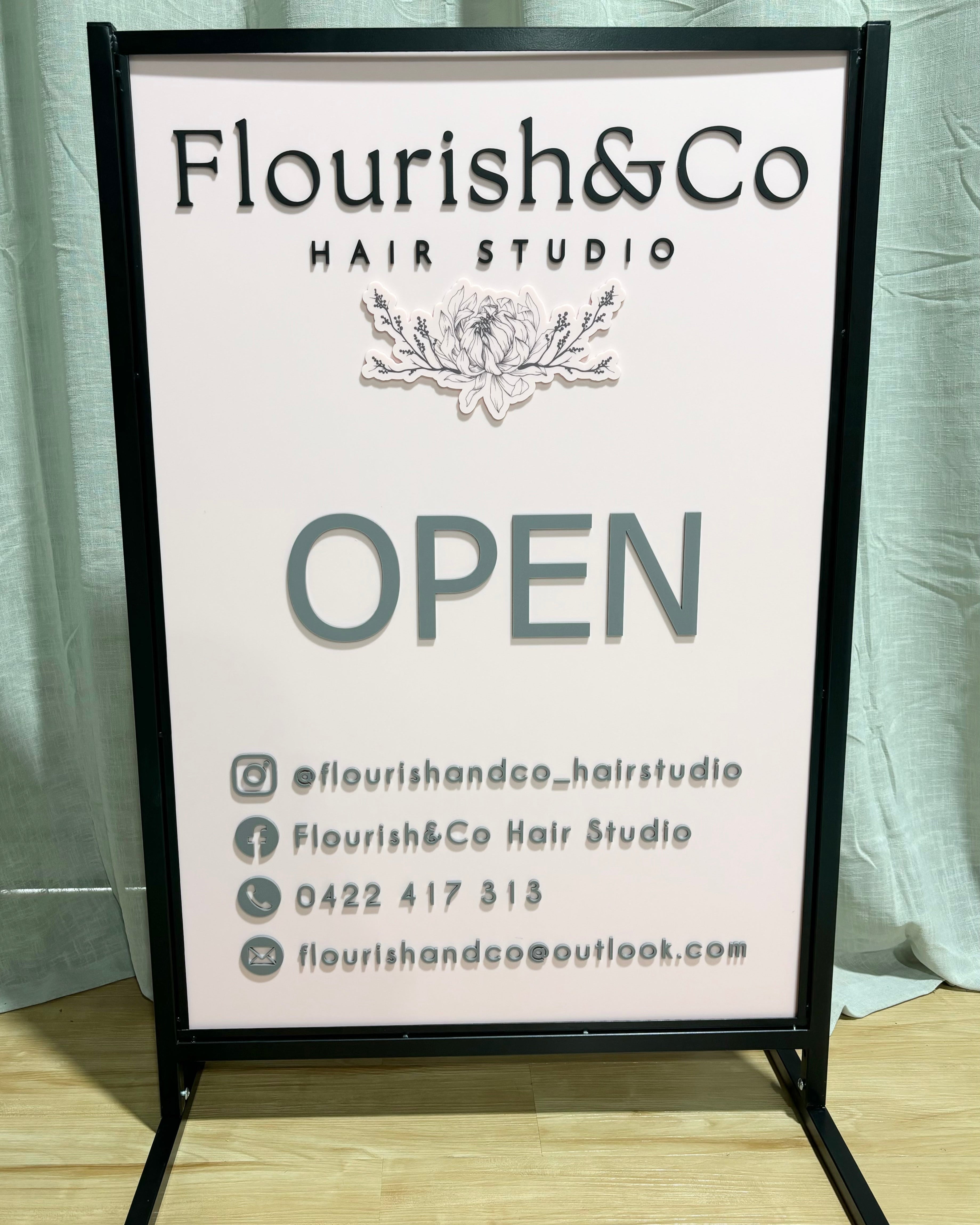 White acrylic T frame outdoor sign displaying open hours