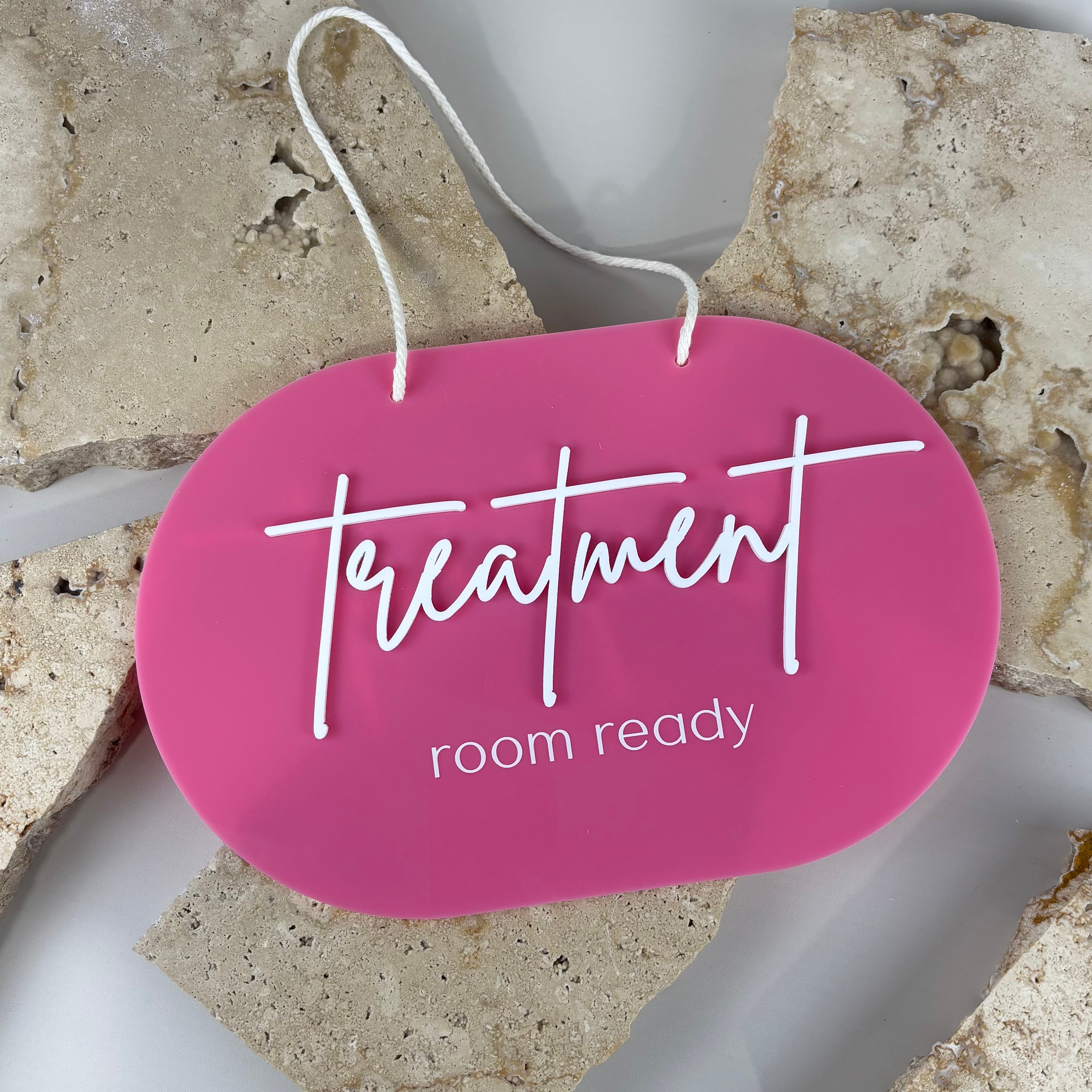 Pink acrylic “Treatment Room Ready” hanging door sign with white raised lettering and rope hanger, professional beauty salon door sign designed for treatment rooms, clinics, lash studios and aesthetic businesses.