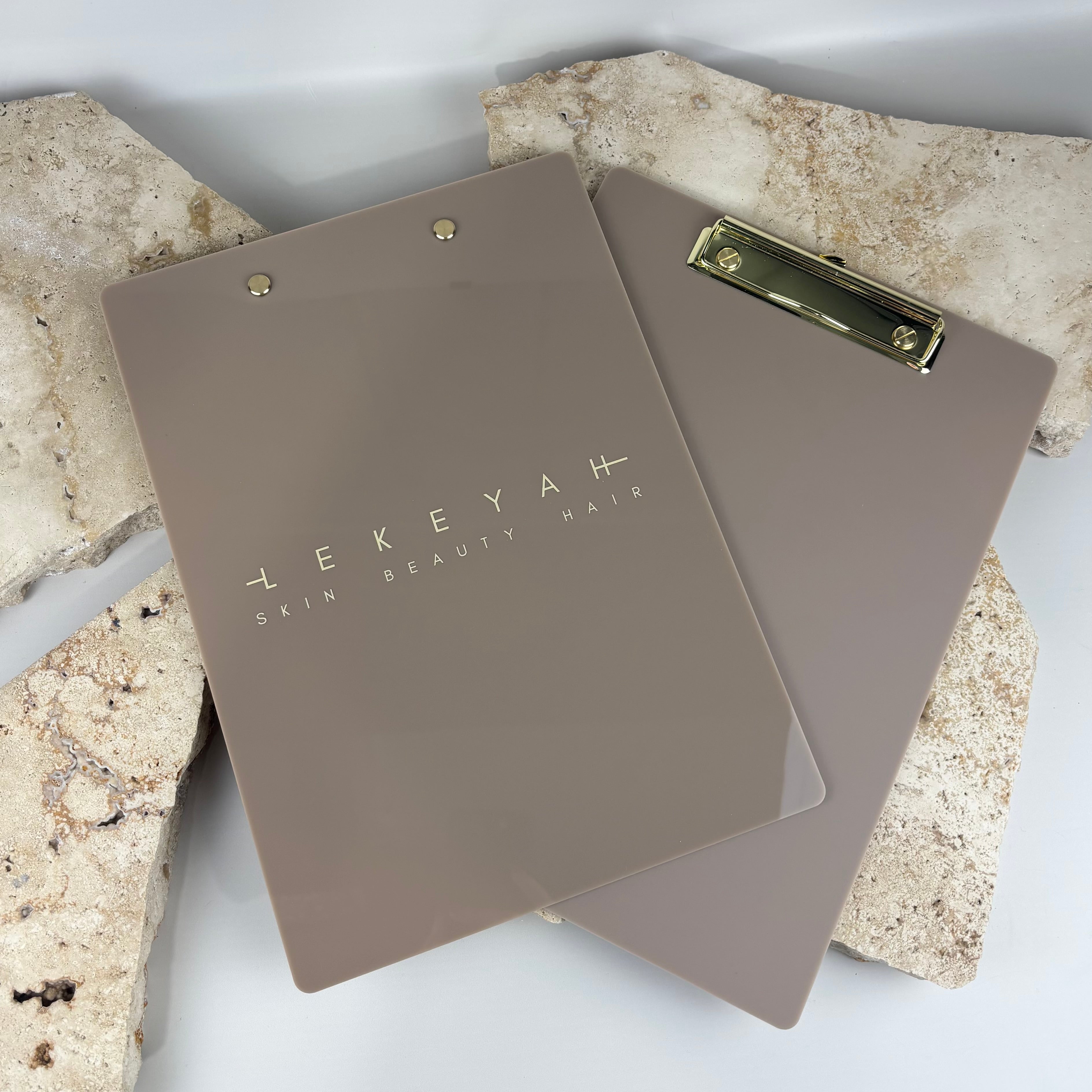 Custom branded acrylic clipboards with gold hardware, premium salon and beauty clinic stationery, personalised logo printed in high quality finish, durable professional client consultation boards for hairdressers and aesthetic businesses, Australian made.