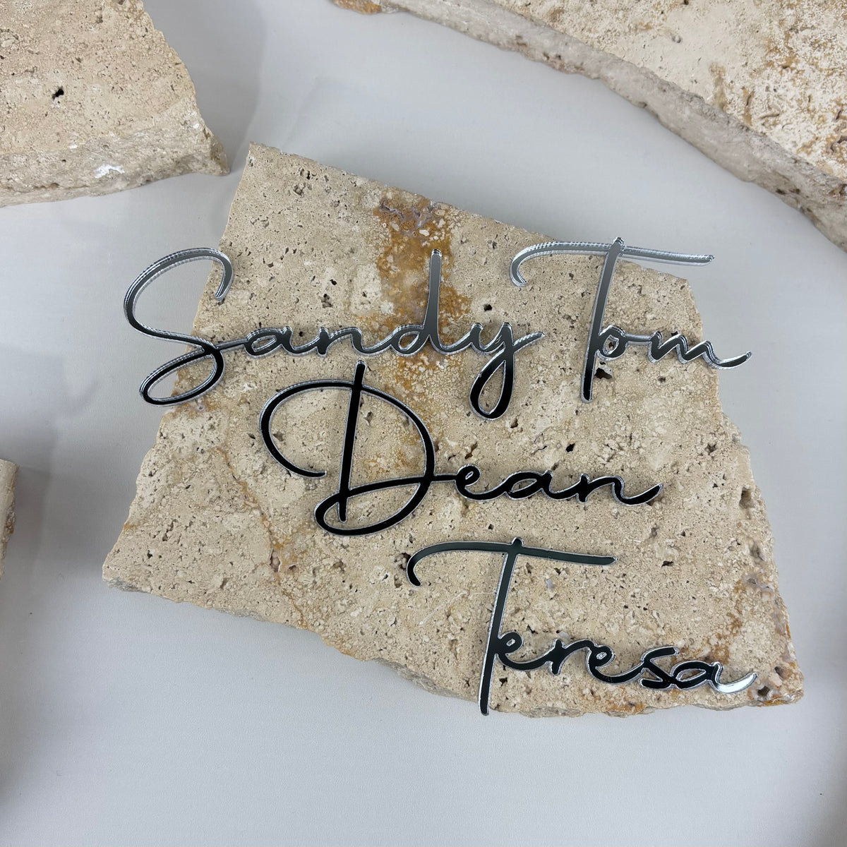 Personalised mirror acrylic name place cards in script font, custom wedding table names for guests, bridal events, parties and special occasions.
