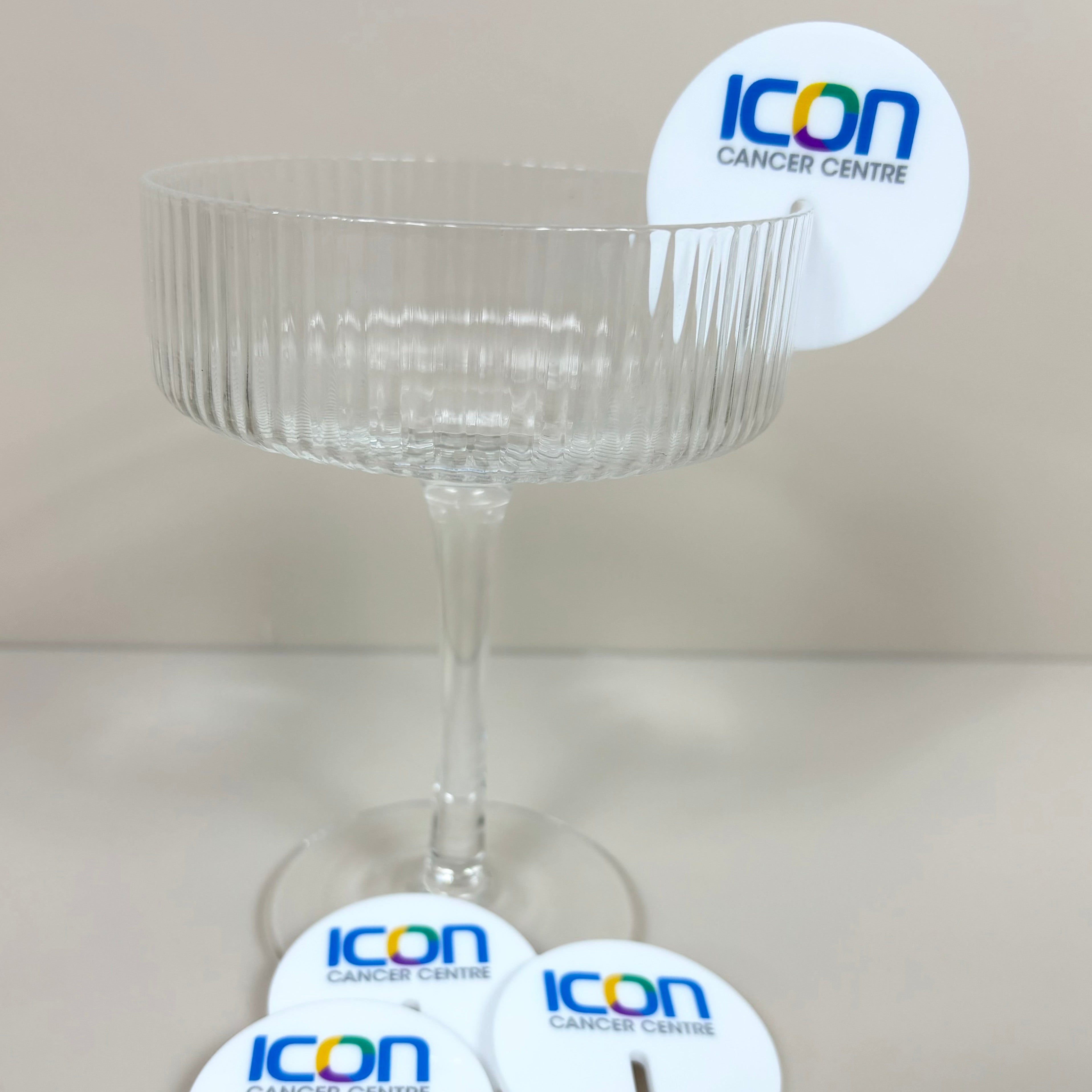Blue and white drink tags with logo on a champagne glass