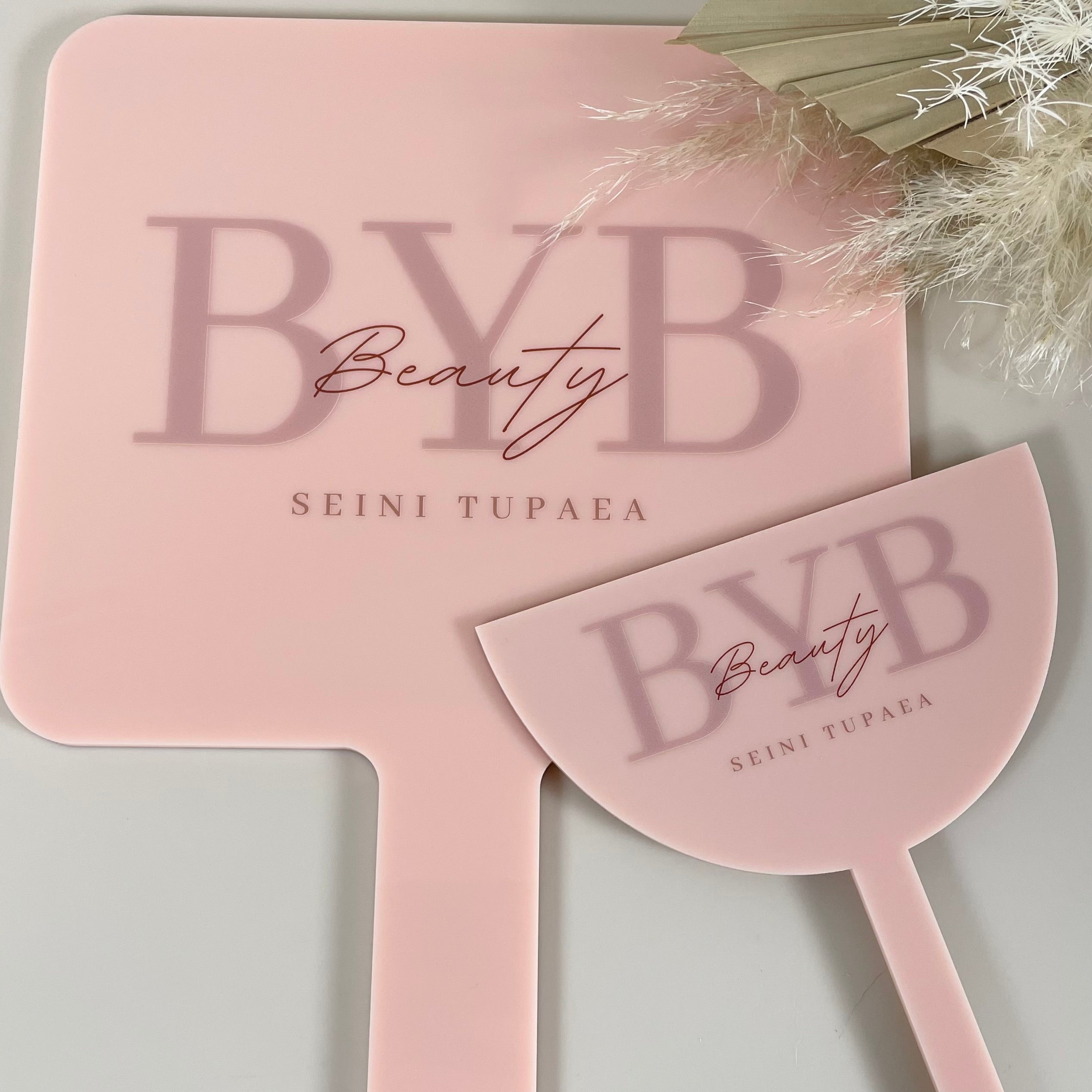 Custom pink handheld mirror and face shield set for beauty salons with engraved BYB Beauty logo