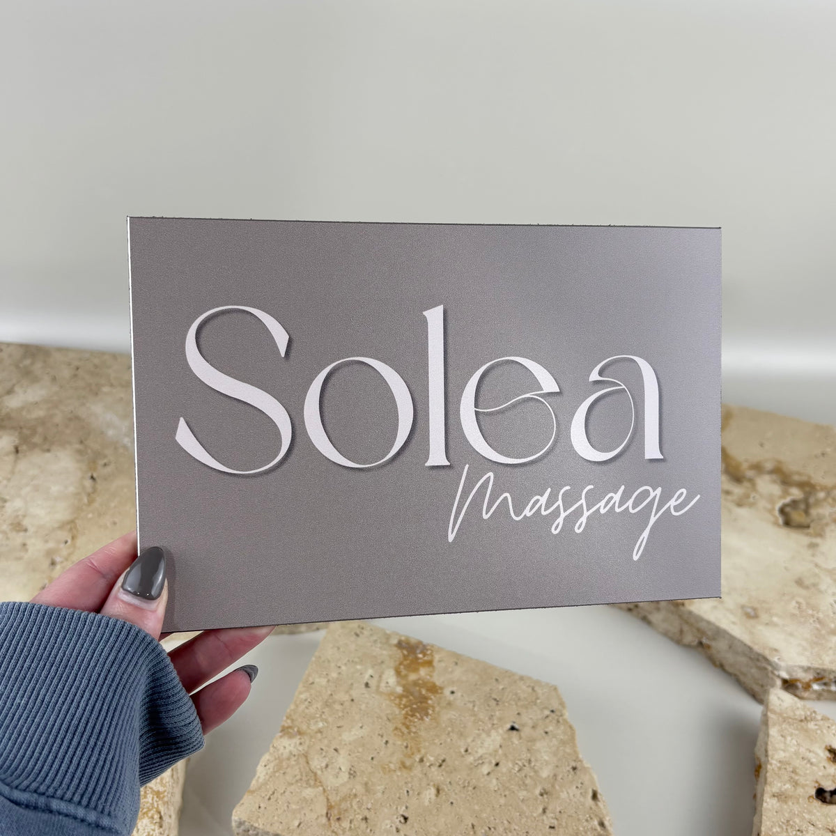 Brushed aluminium business sign with white UV printed Solea Massage logo, featuring a sleek metallic finish for premium spas, massage clinics, wellness centres and professional business branding.