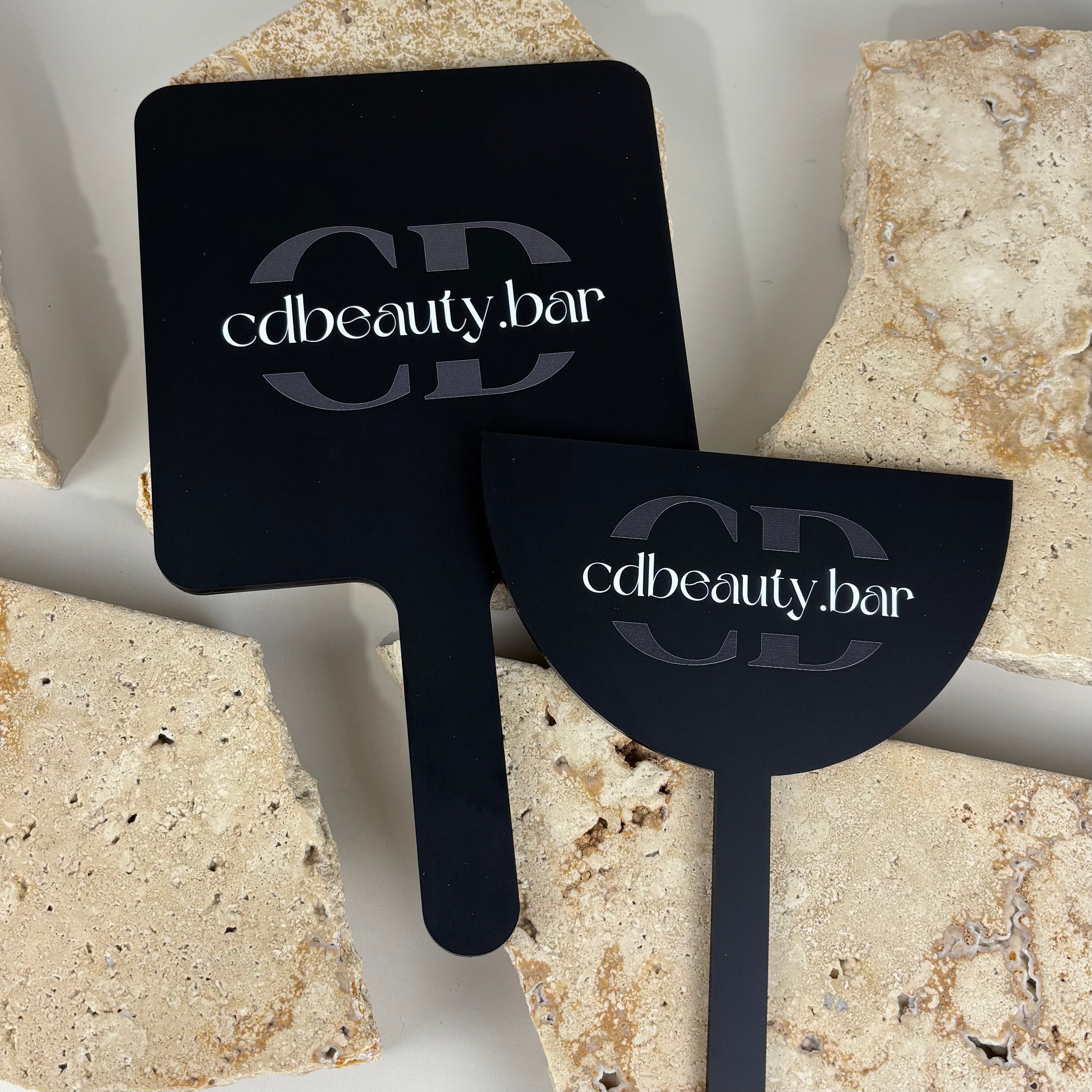 Matte black acrylic handheld beauty mirrors with cdbeauty.bar branding, modern salon mirror ideal for lash, brow and beauty studios for client reveals and photos.
