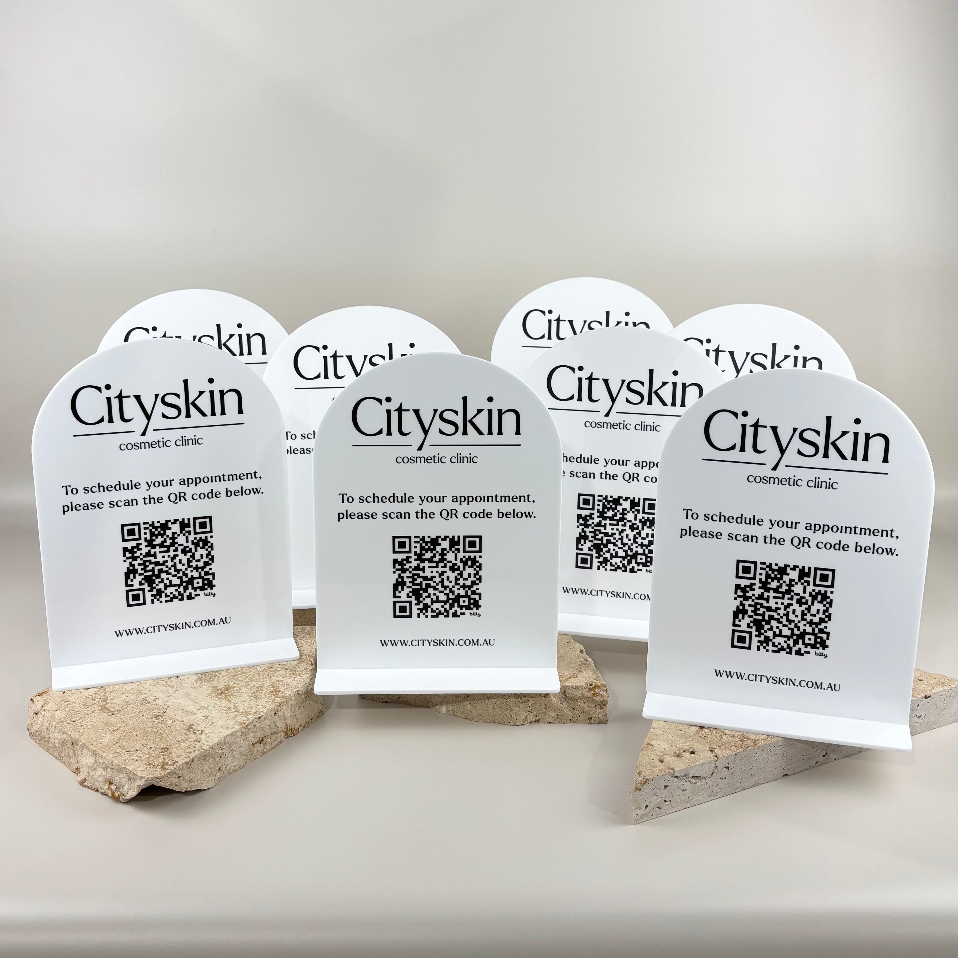 Custom white acrylic QR code appointment signs with black UV printed Cityskin Cosmetic Clinic branding for easy online booking.