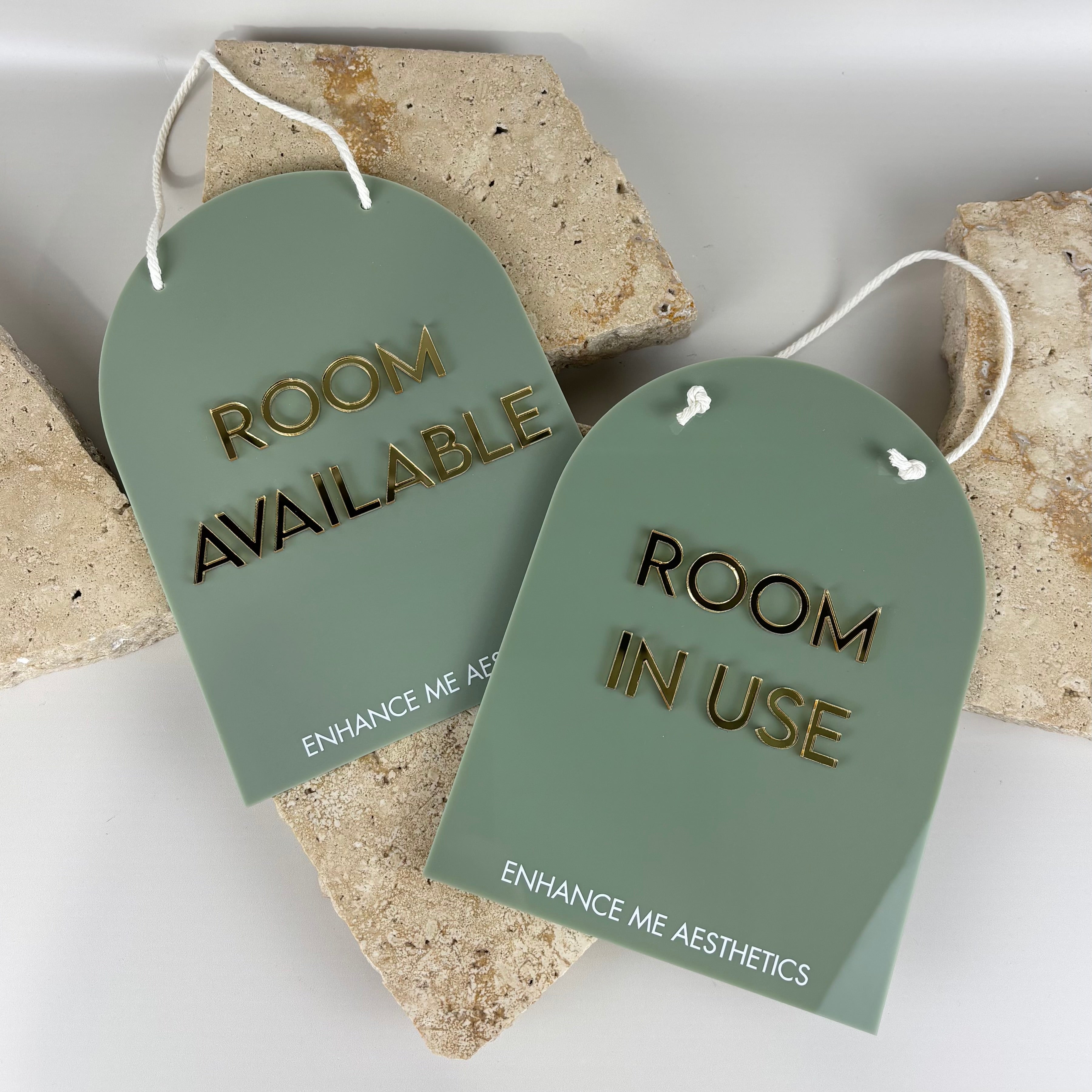 Custom sage green acrylic room signs with gold lettering, Room Available and Room In Use door hangers for beauty clinic or aesthetics studio