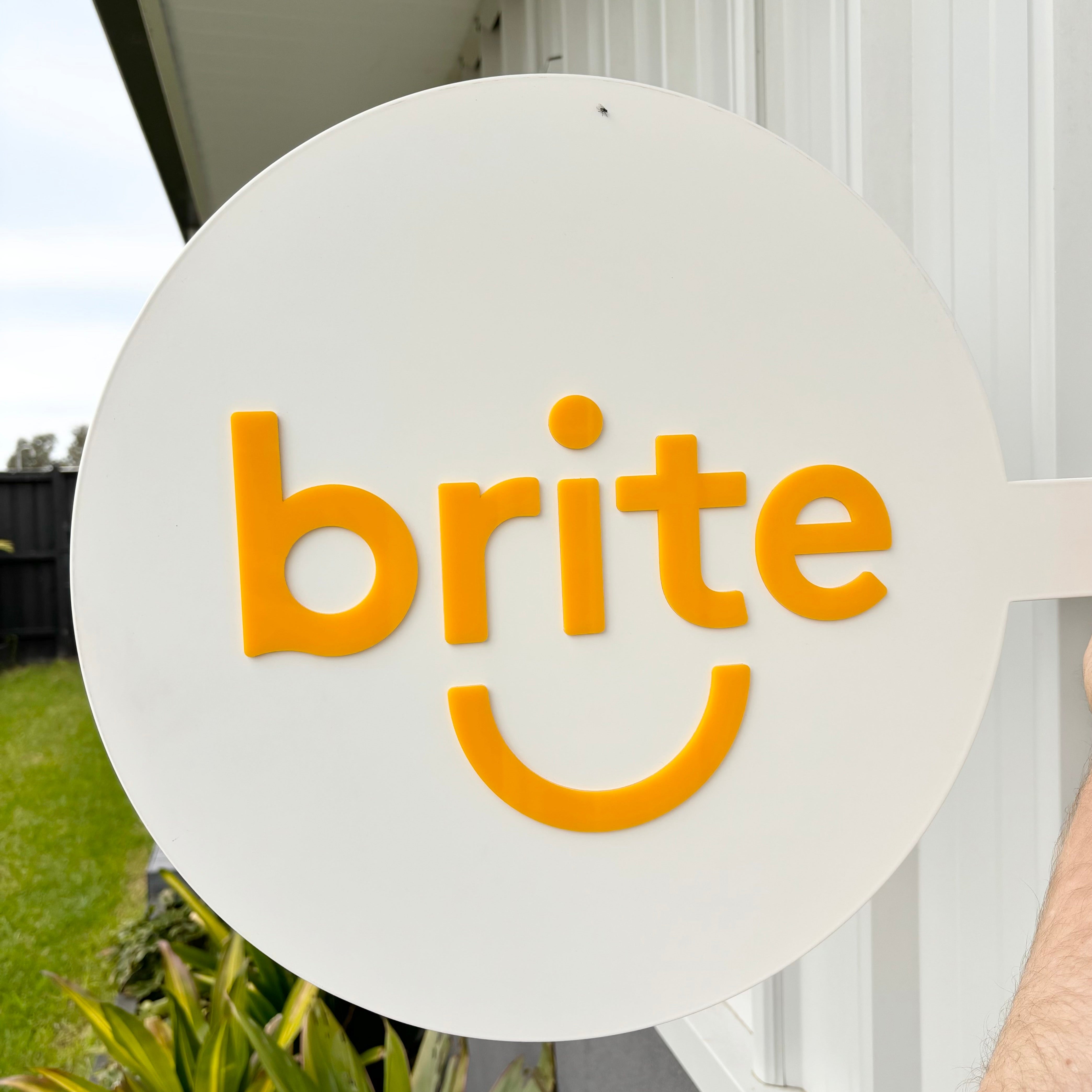 Brite smiley face round acrylic sign for dental or wellness studio