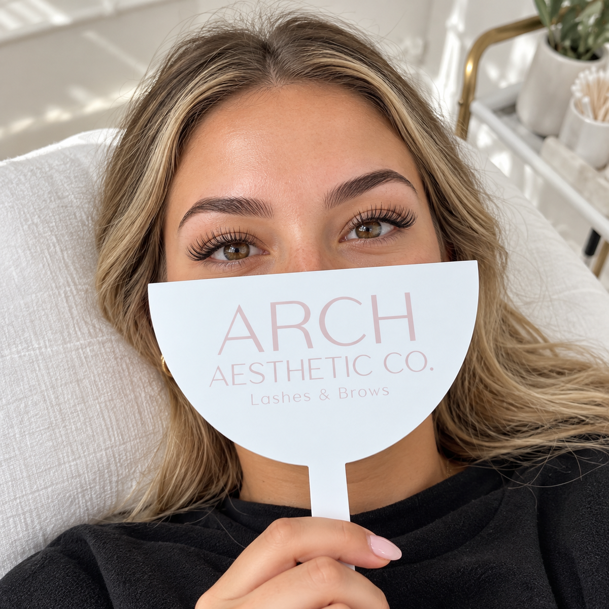 Custom branded photo shield for lash and brow salons, covering the client’s nose and mouth while keeping the eyes and brows visible for treatment photos.