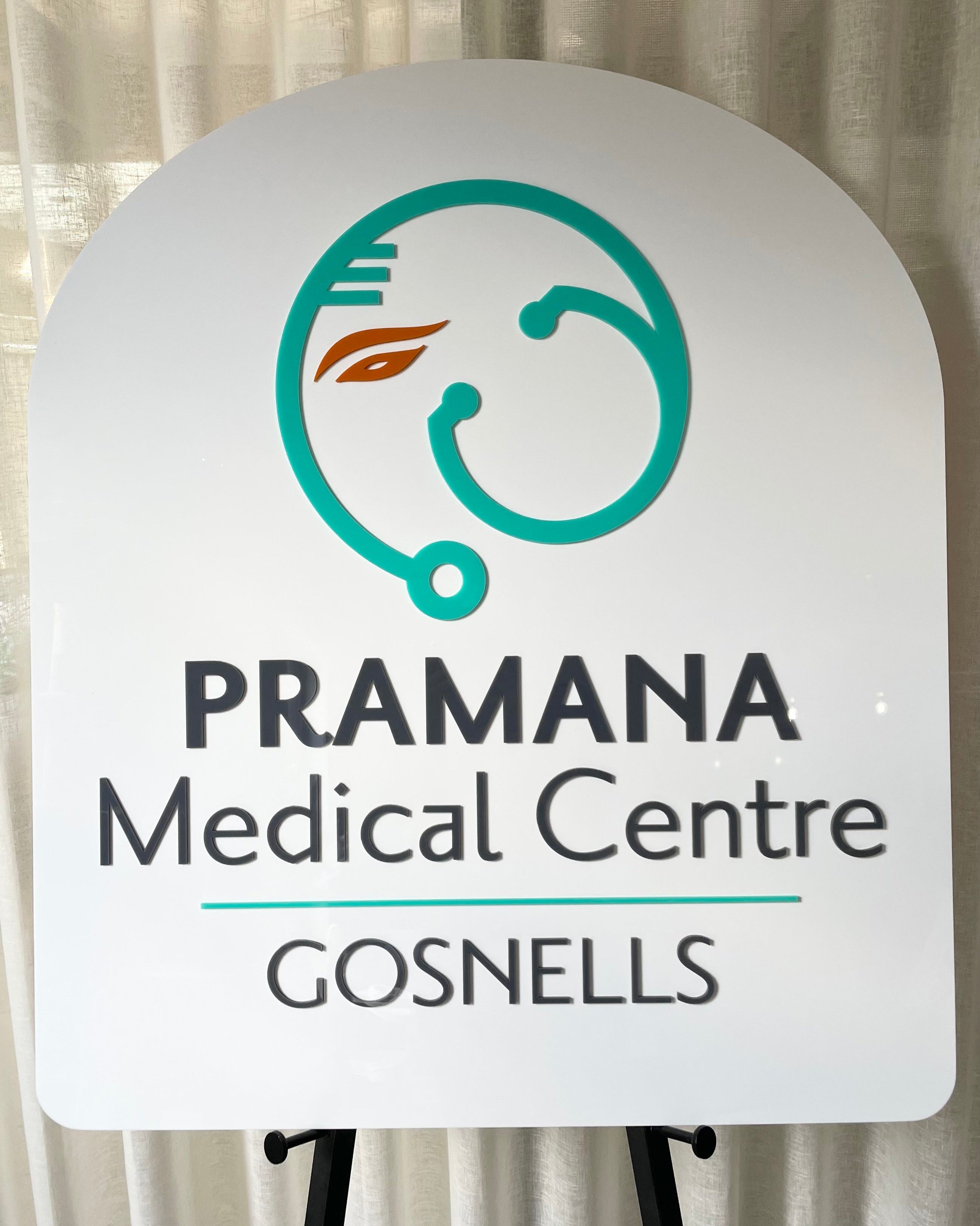 White arch sign with medical centre branding