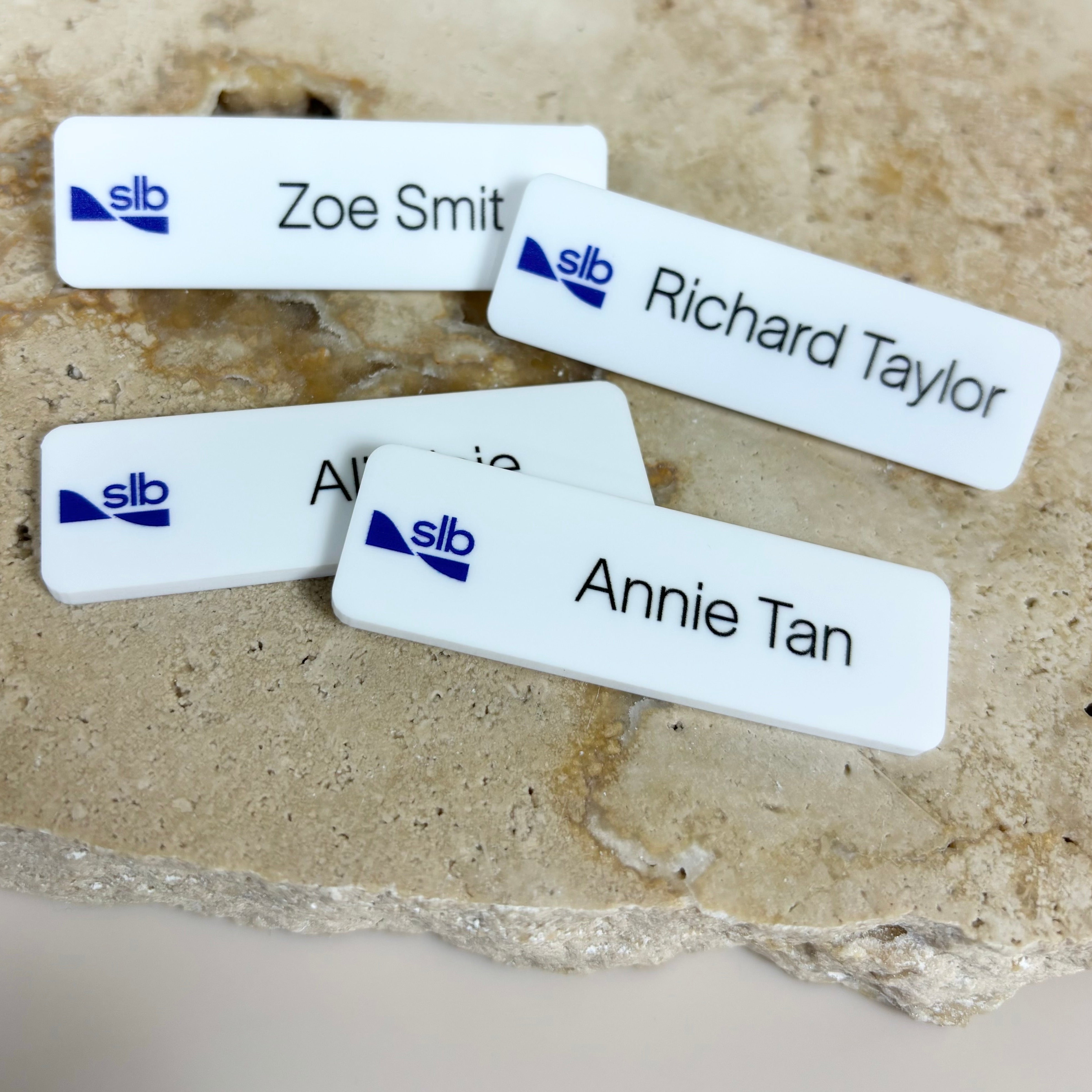 White name badge with logo and name