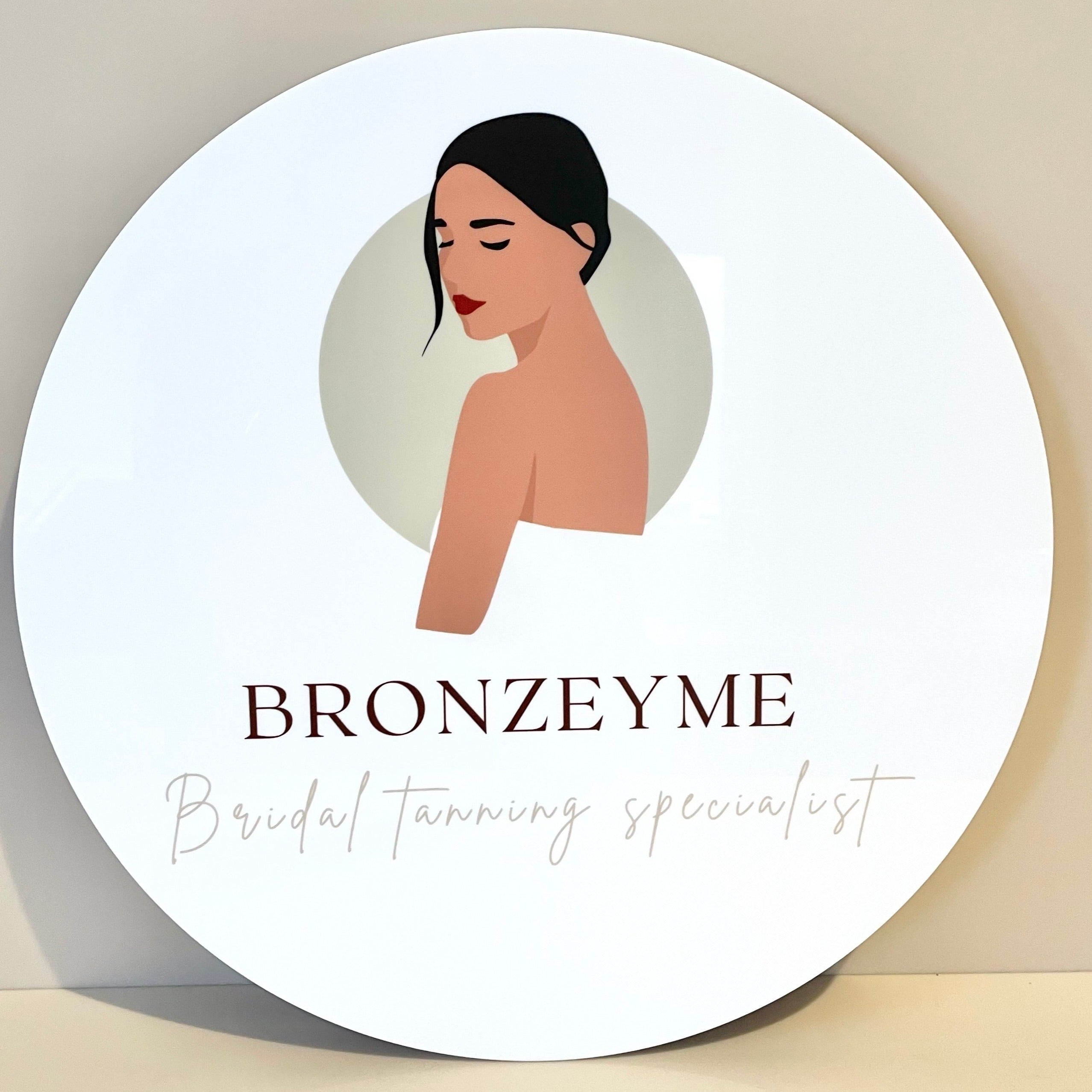 Clean white business sign with illustrated logo for BRONZEY ME