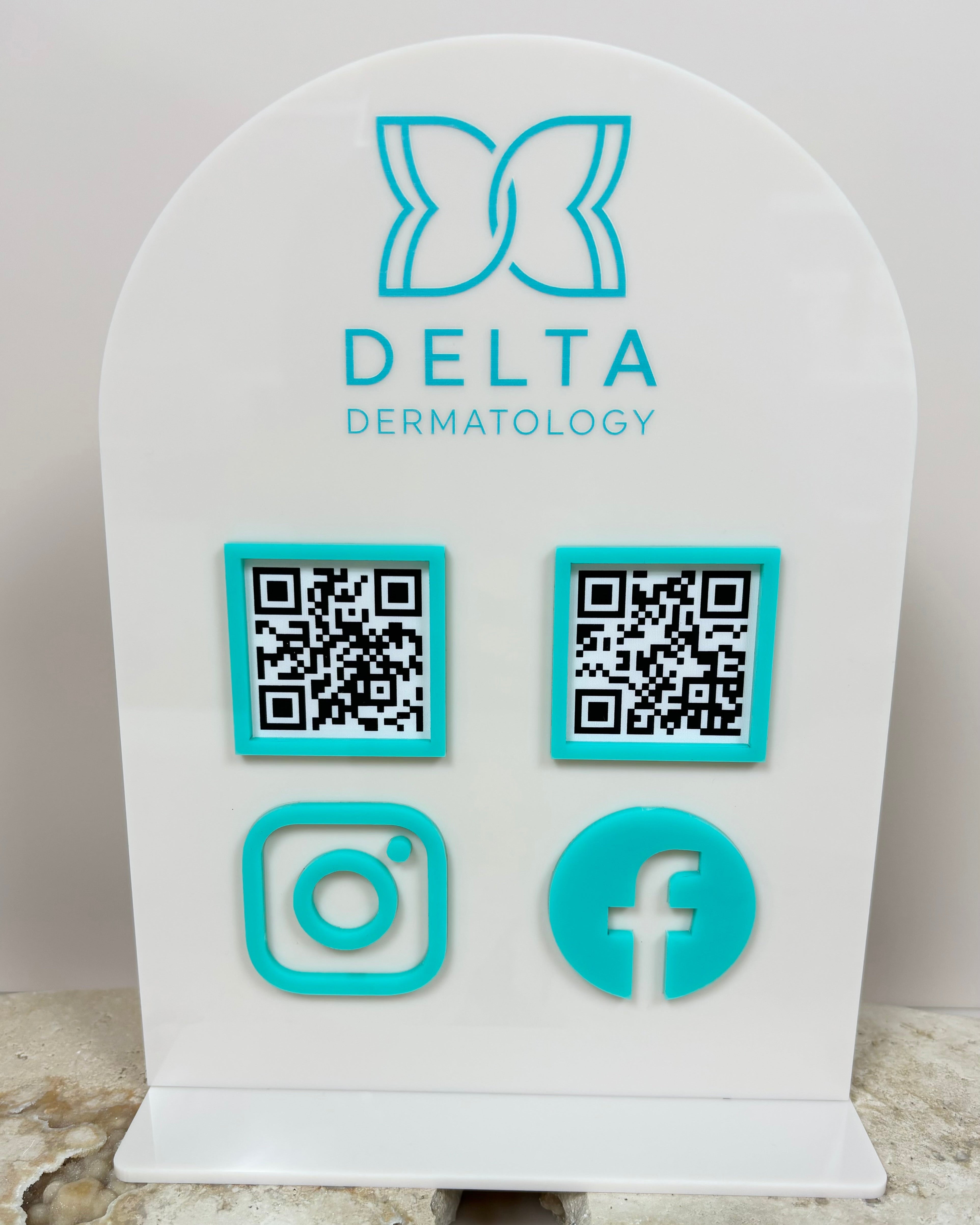 Custom skincare clinic social media QR code display with Instagram and Facebook icons