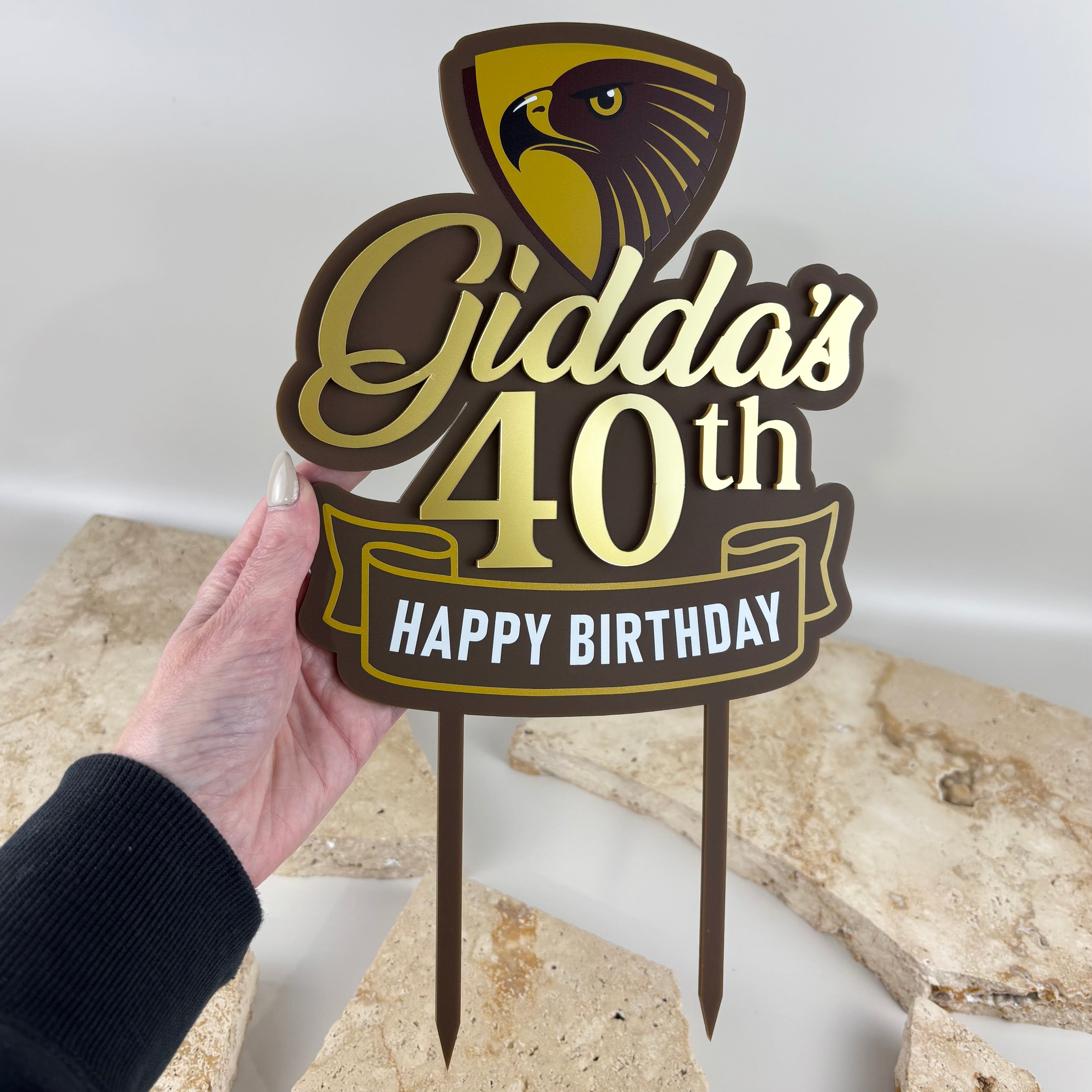 Custom 40th birthday cake topper with brown and gold acrylic, personalised name, happy birthday text and hawk design.