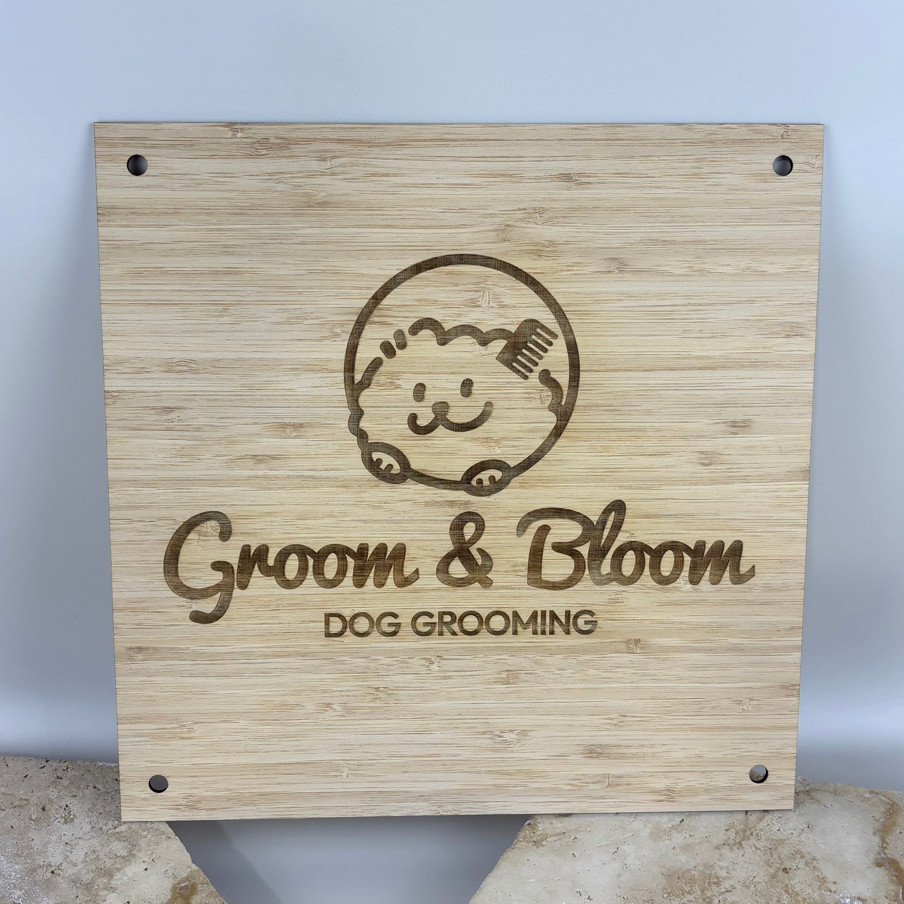 Custom engraved bamboo business sign with personalised logo, wooden wall signage for dog groomers, salons, beauty businesses, clinics and small businesses.