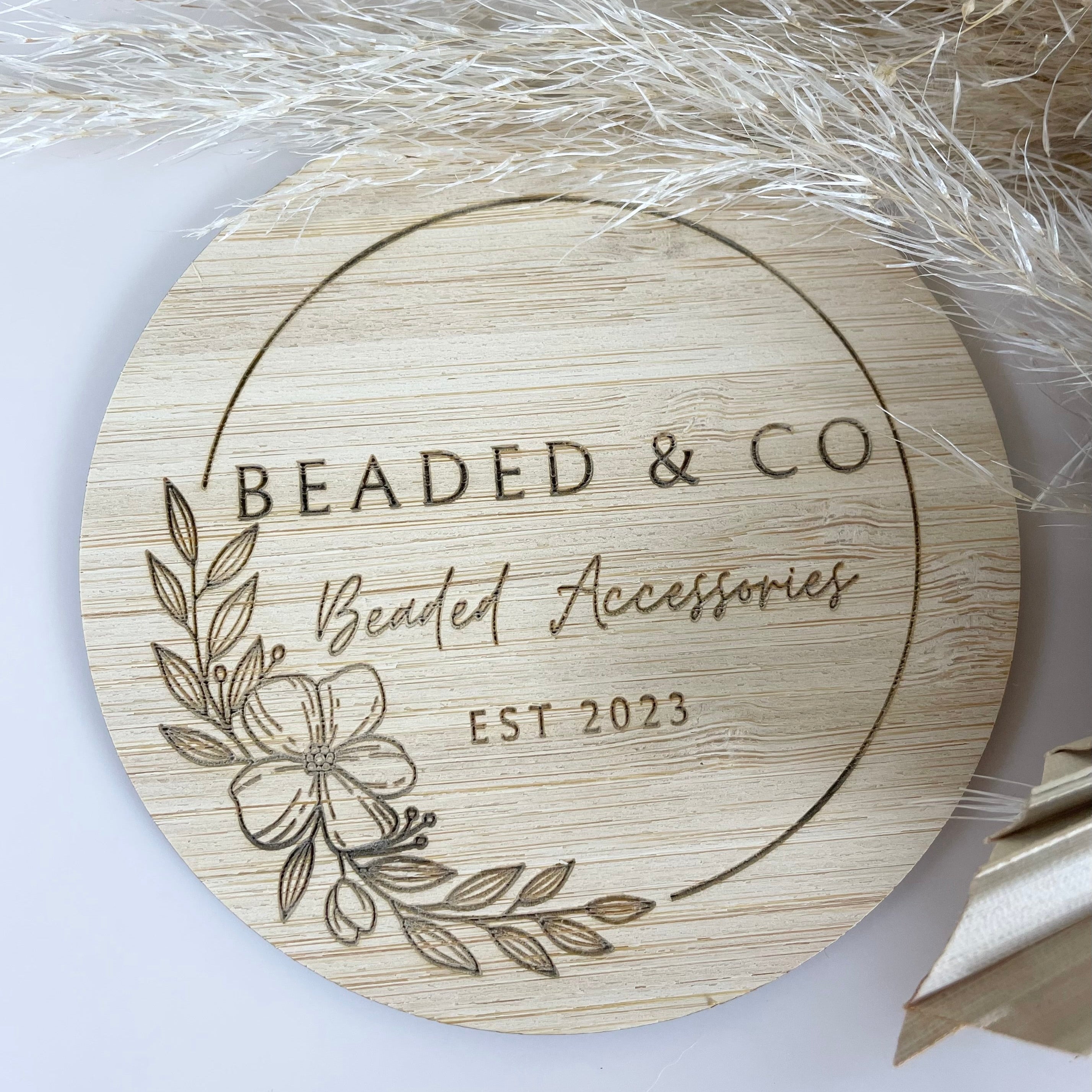 Eco‑friendly bamboo logo disc with custom logo engraving – prop for product photo shoots