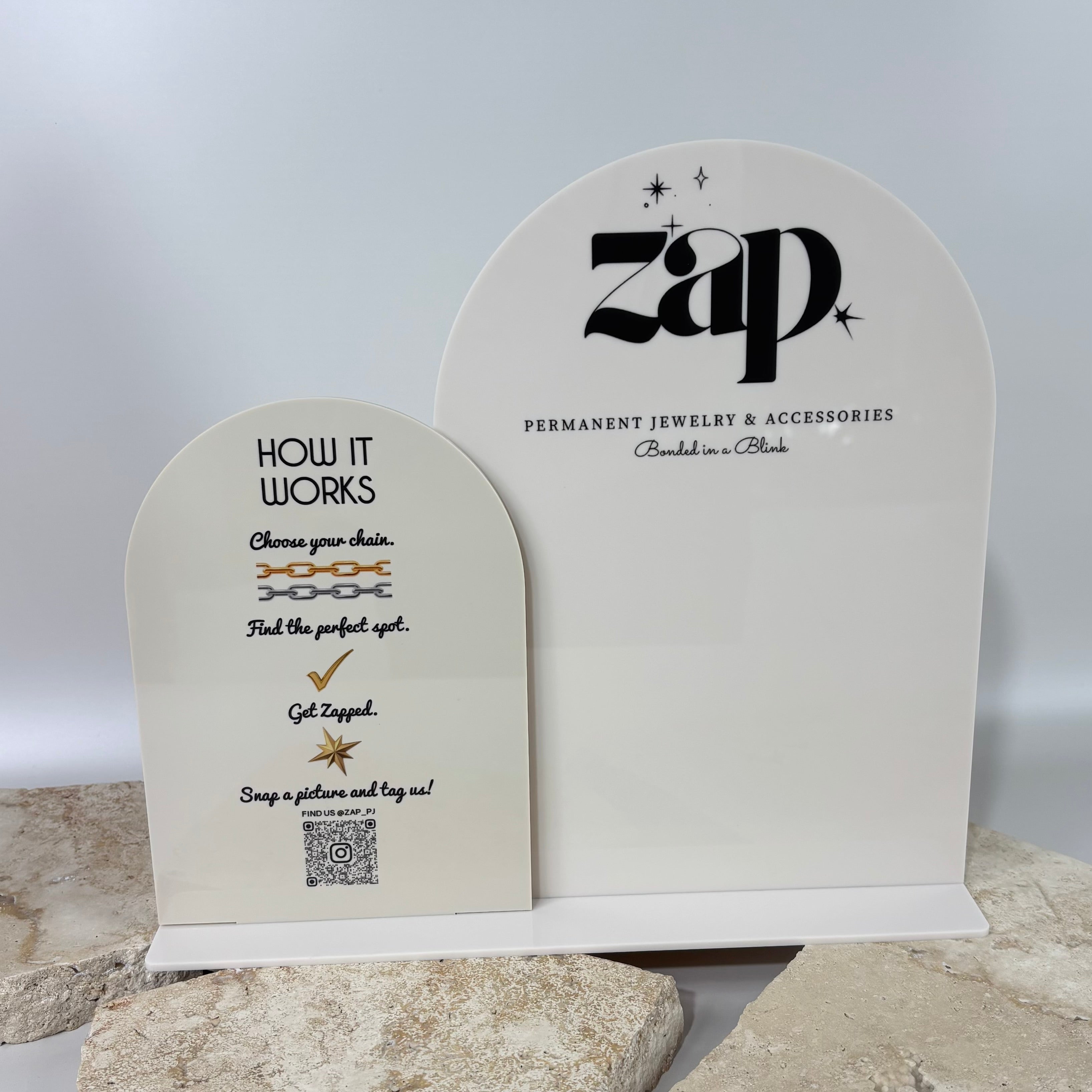 Freestanding dual acrylic menu signs with black text and curved layout