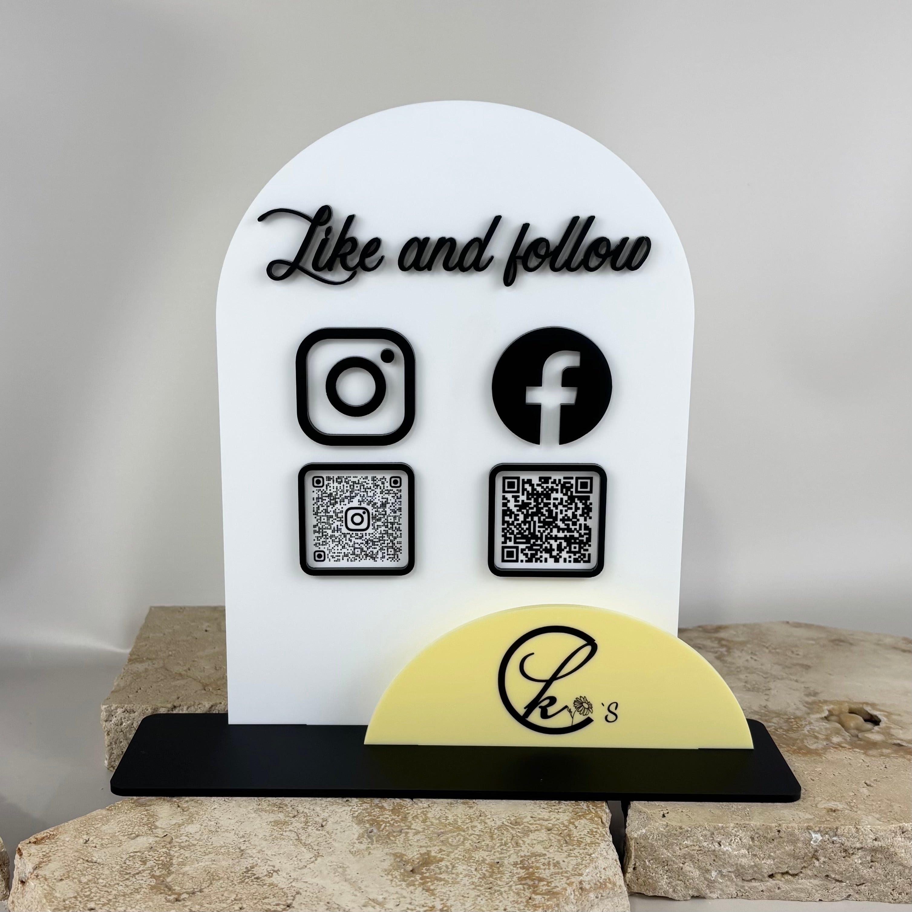Custom white acrylic social media sign with Instagram and Facebook icons, QR codes and Like and Follow text for business display