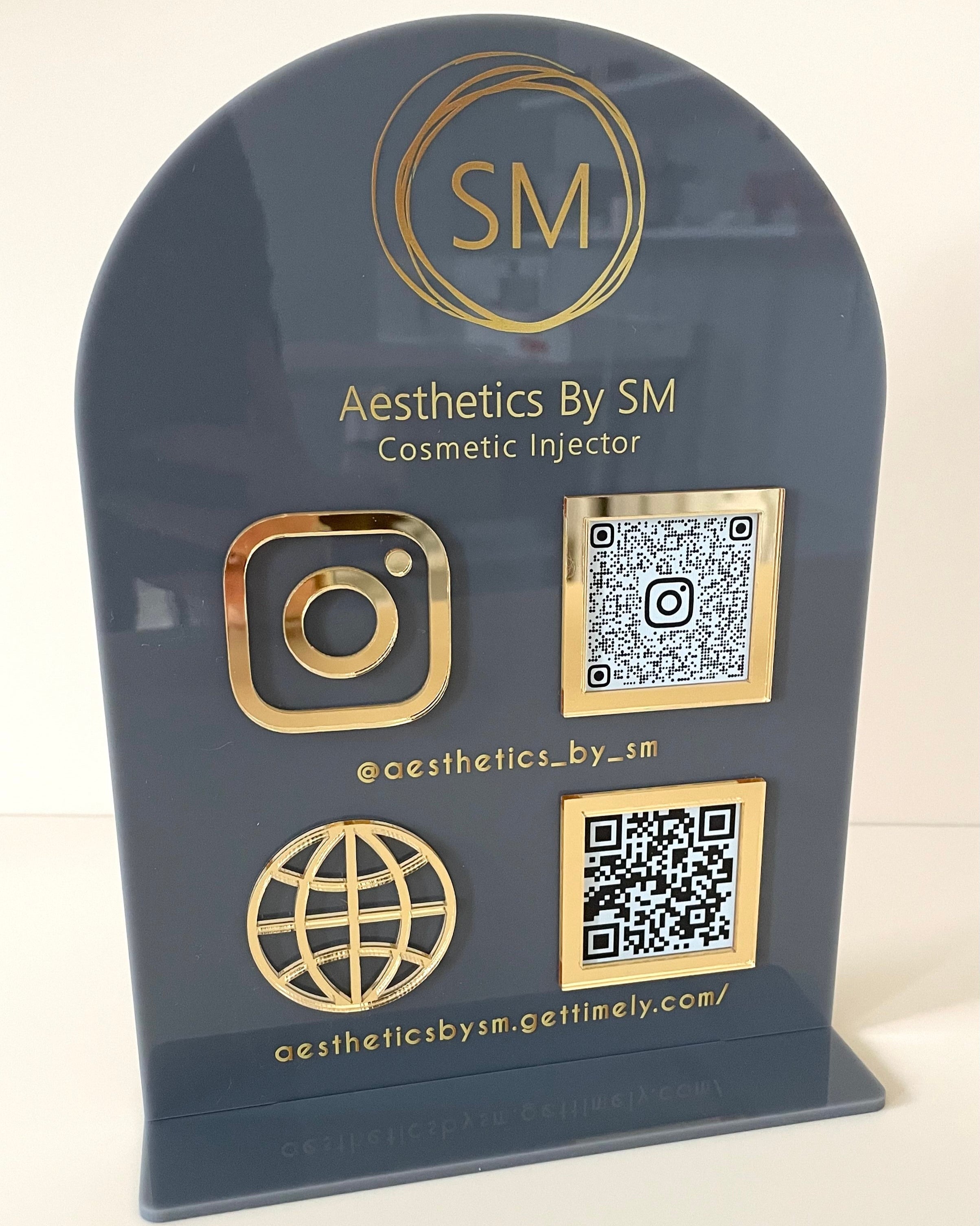 Gold and black acrylic social media QR code stand for beauty business