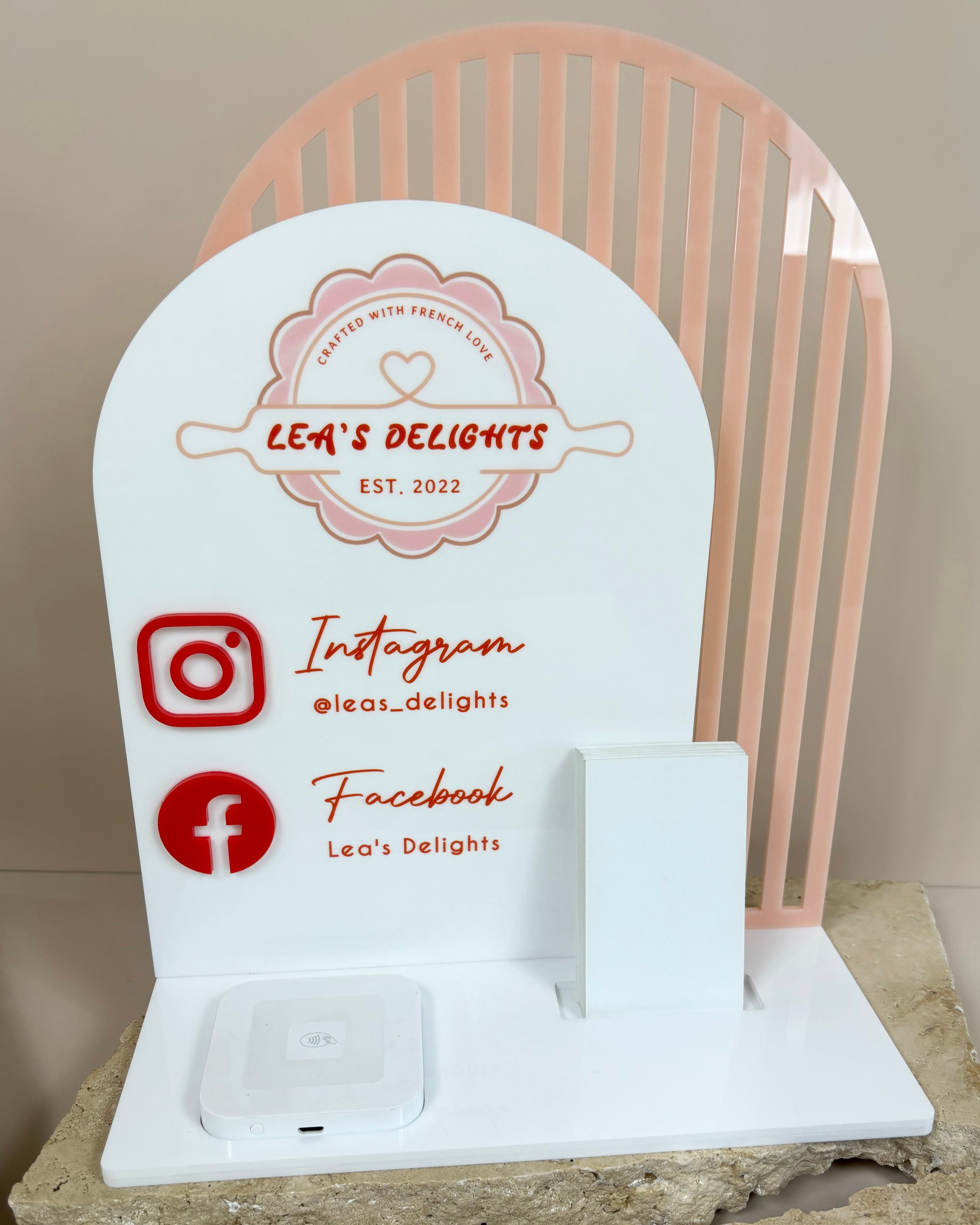White acrylic business station stand with Instagram and Facebook icons
