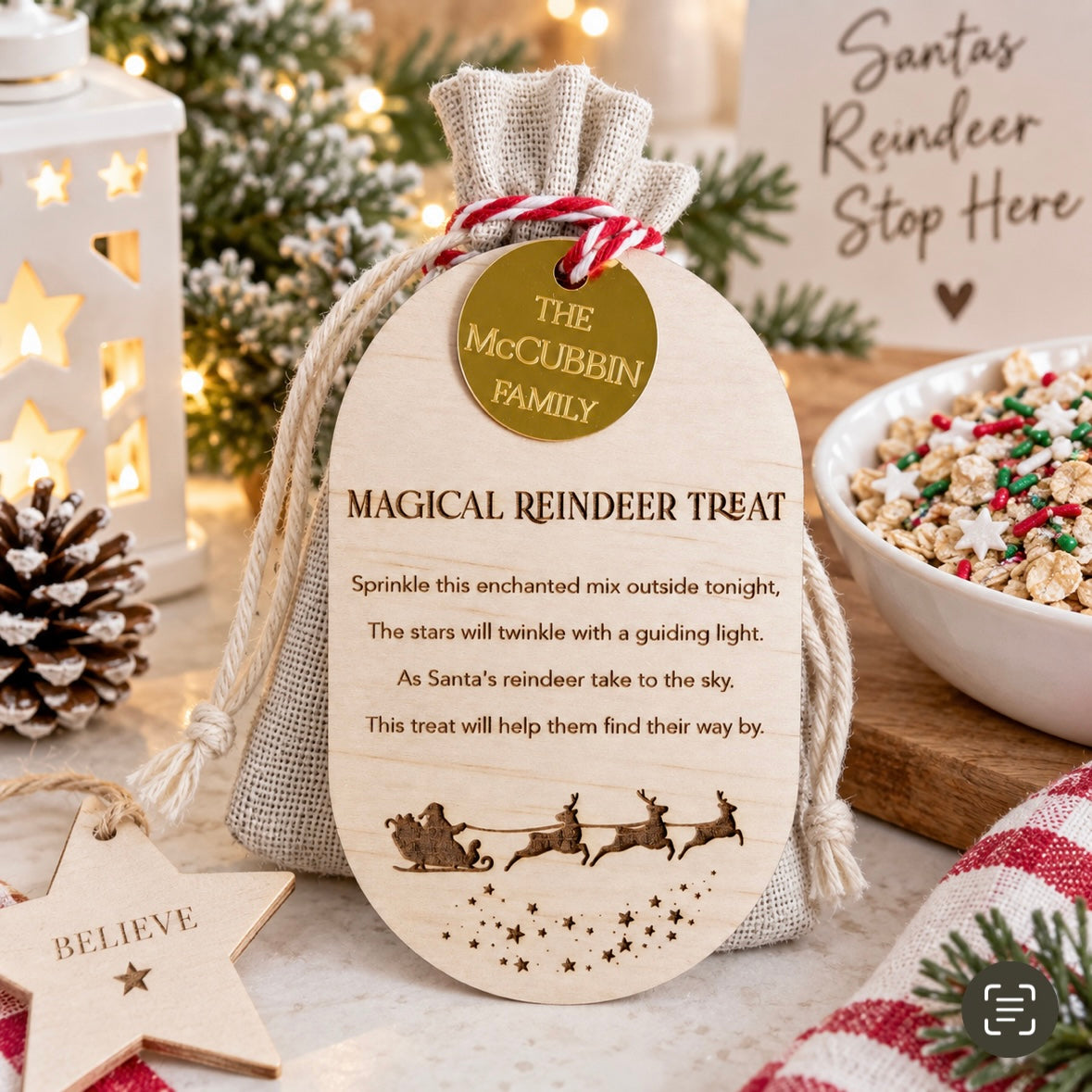 Personalised magical reindeer food Christmas bag with engraved wooden tag and family name, displayed in a light modern Christmas setting with festive decorations.