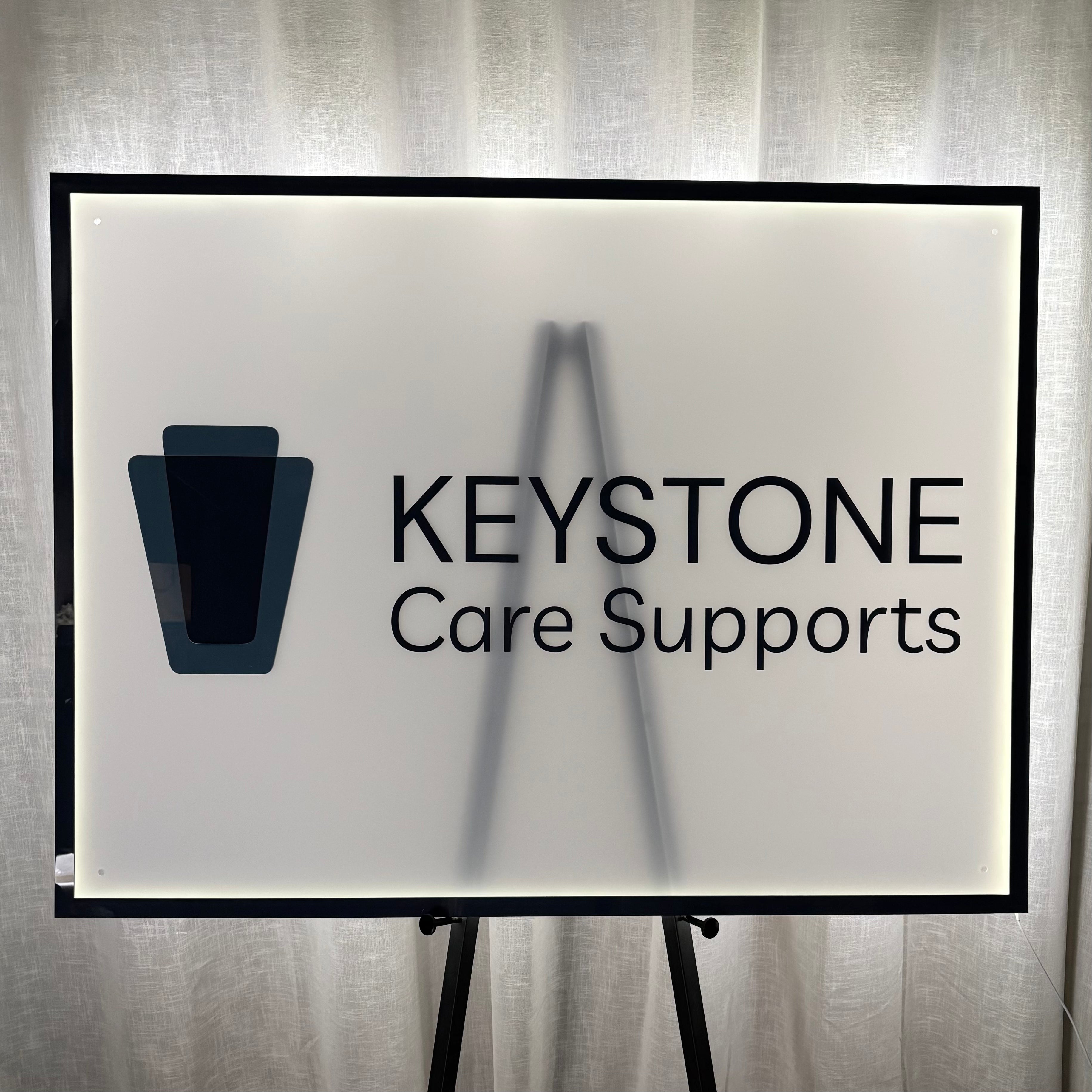 Custom rectangular backlit LED business sign with personalised logo, illuminated acrylic wall sign for offices, clinics, care providers and professional businesses.