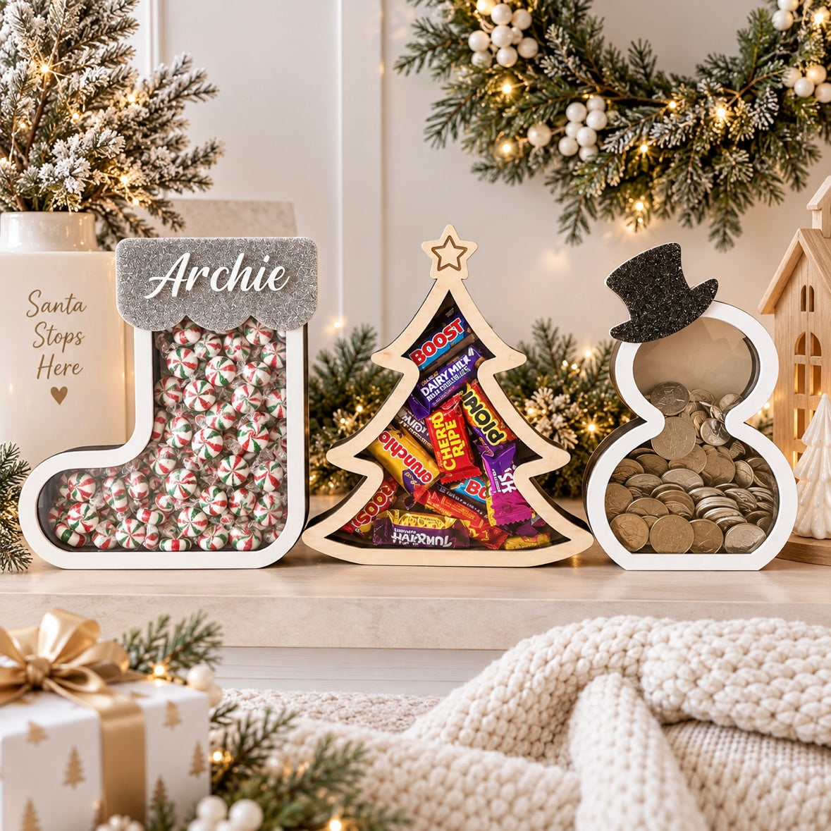 Christmas stocking, Christmas tree and snowman drop boxes for lollies, chocolates and coins, displayed in a light modern Christmas setting with festive decorations.