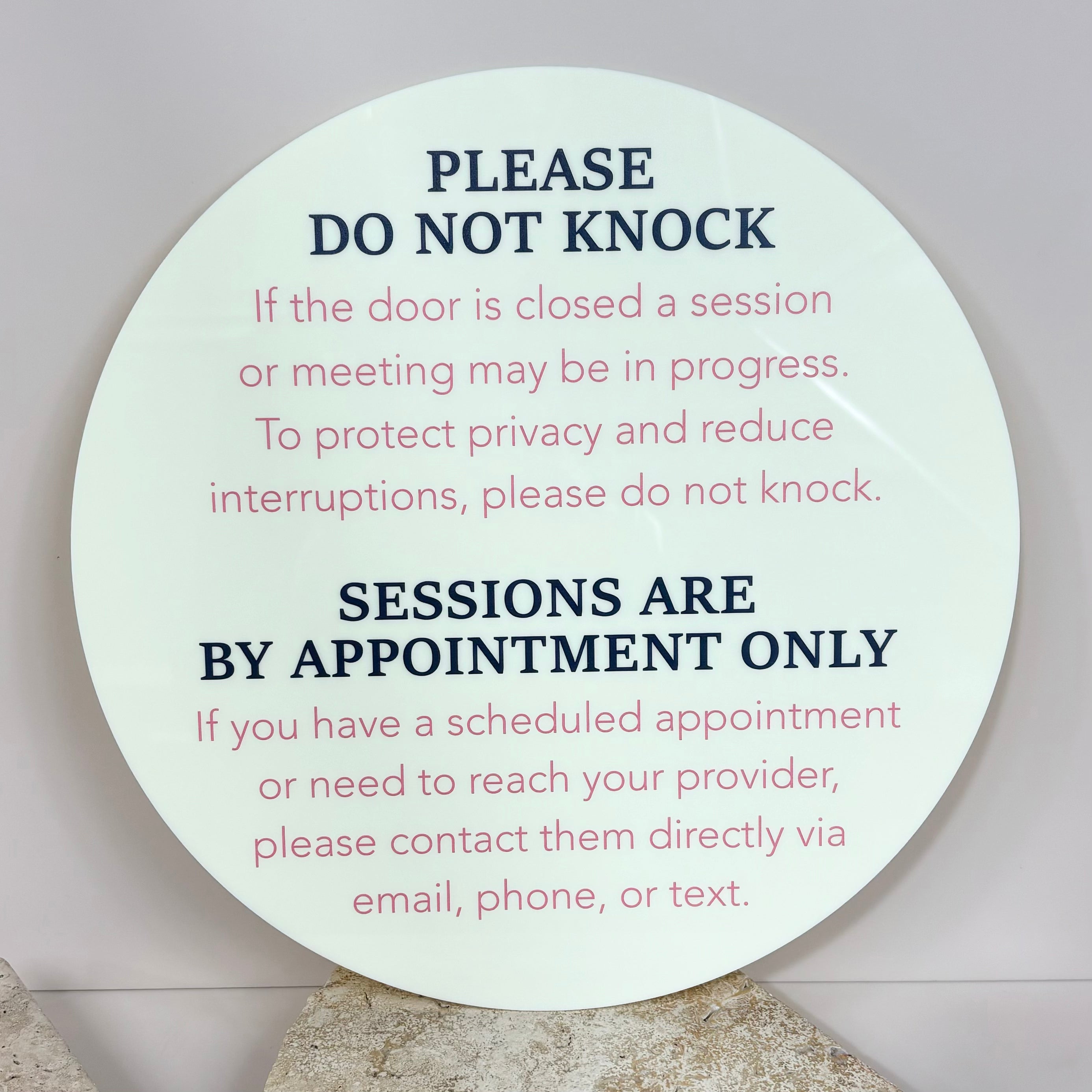 Do not knock sessions by appointment only sign in white acrylic with pink text