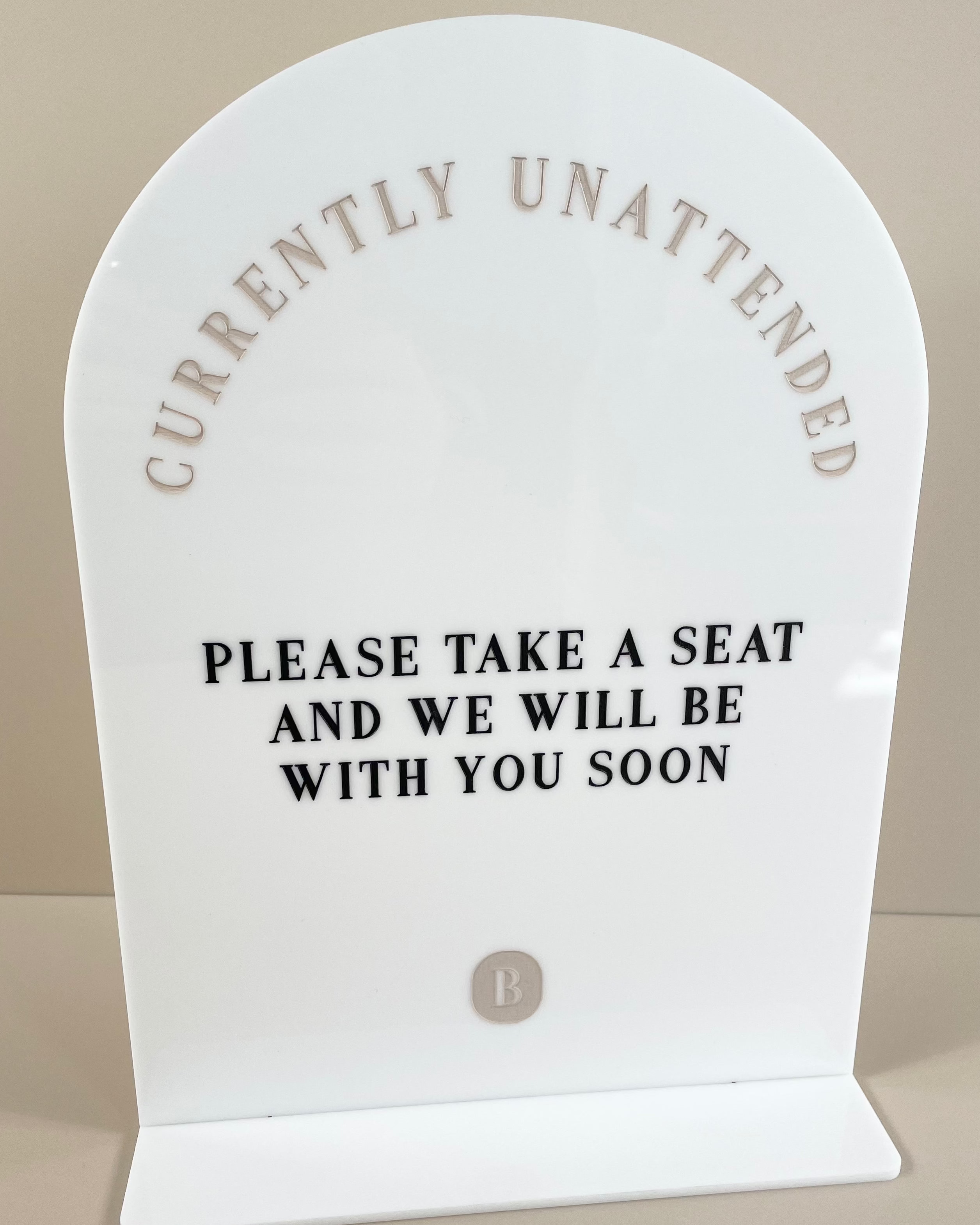 Currently unattended white business counter sign